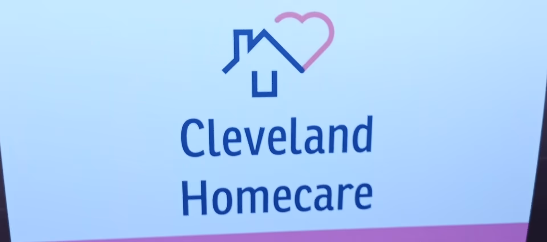 Sign reads Cleveland Homecare with a blue house and pink heart logo