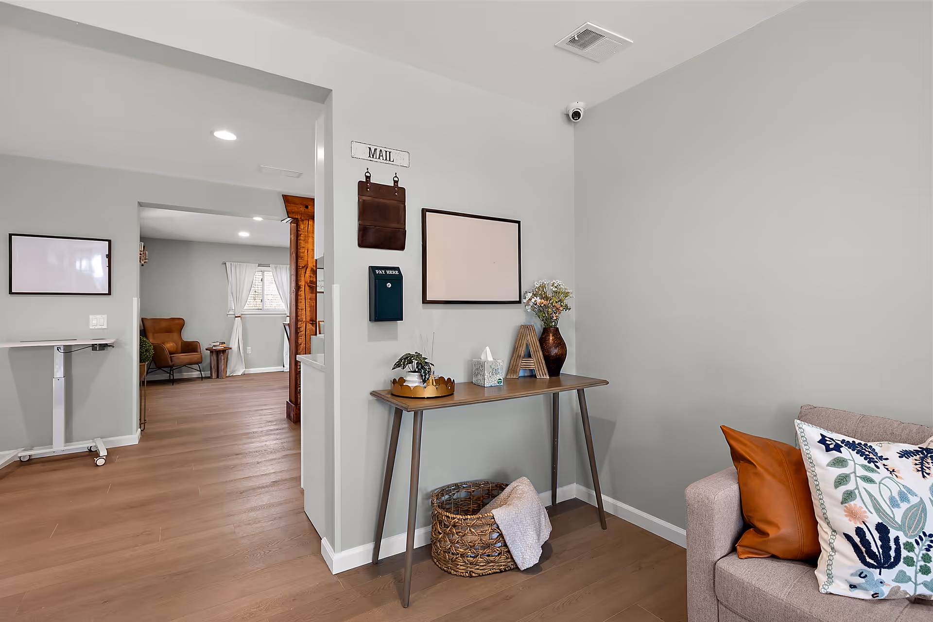 Cozy living area in a boutique senior facility with sofa, console table, and decor.