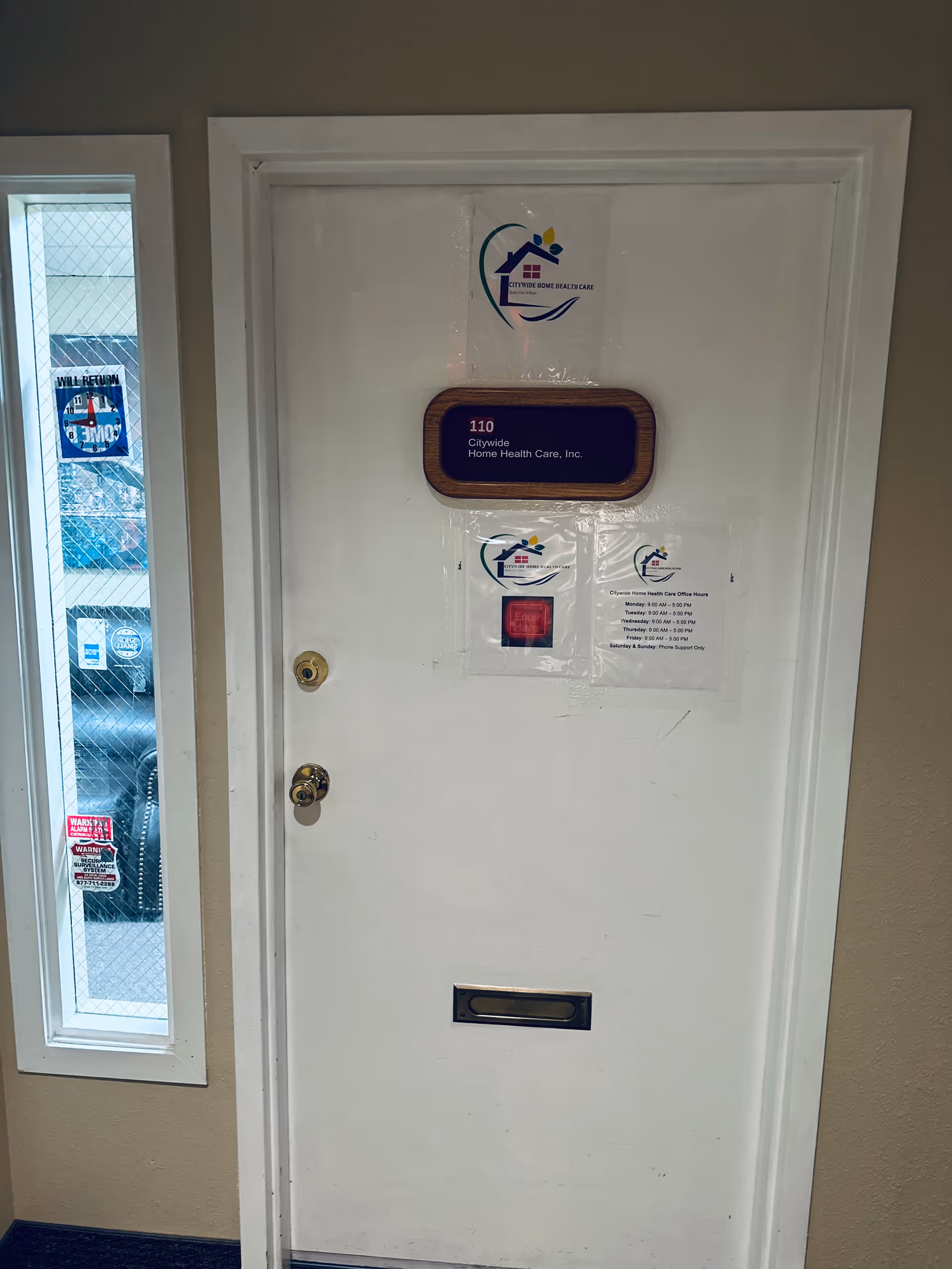 White interior door with Citywide Home Health Care signage in a hallway