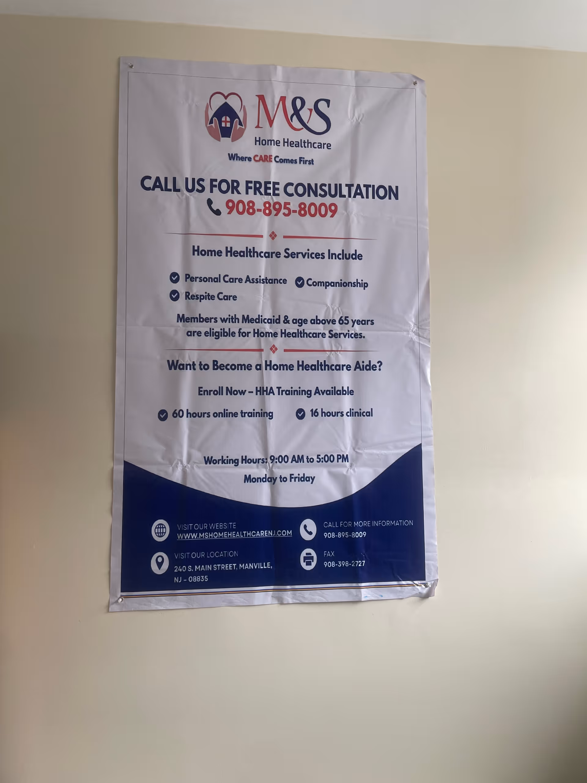 Large vertical banner on a wall advertising M&S Home Healthcare services and contact info.