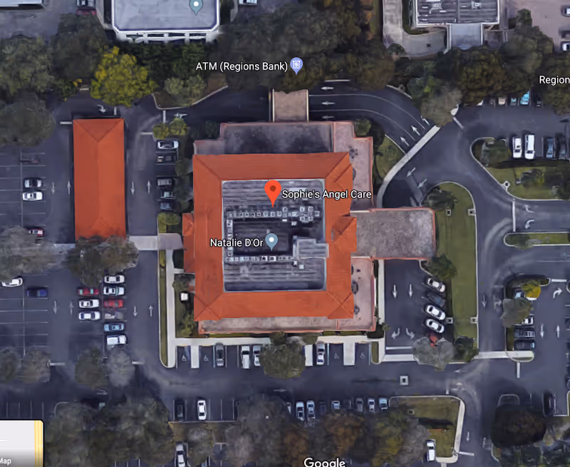 Aerial view of Sophie's Angel Care facility with a red-roofed building and parking.