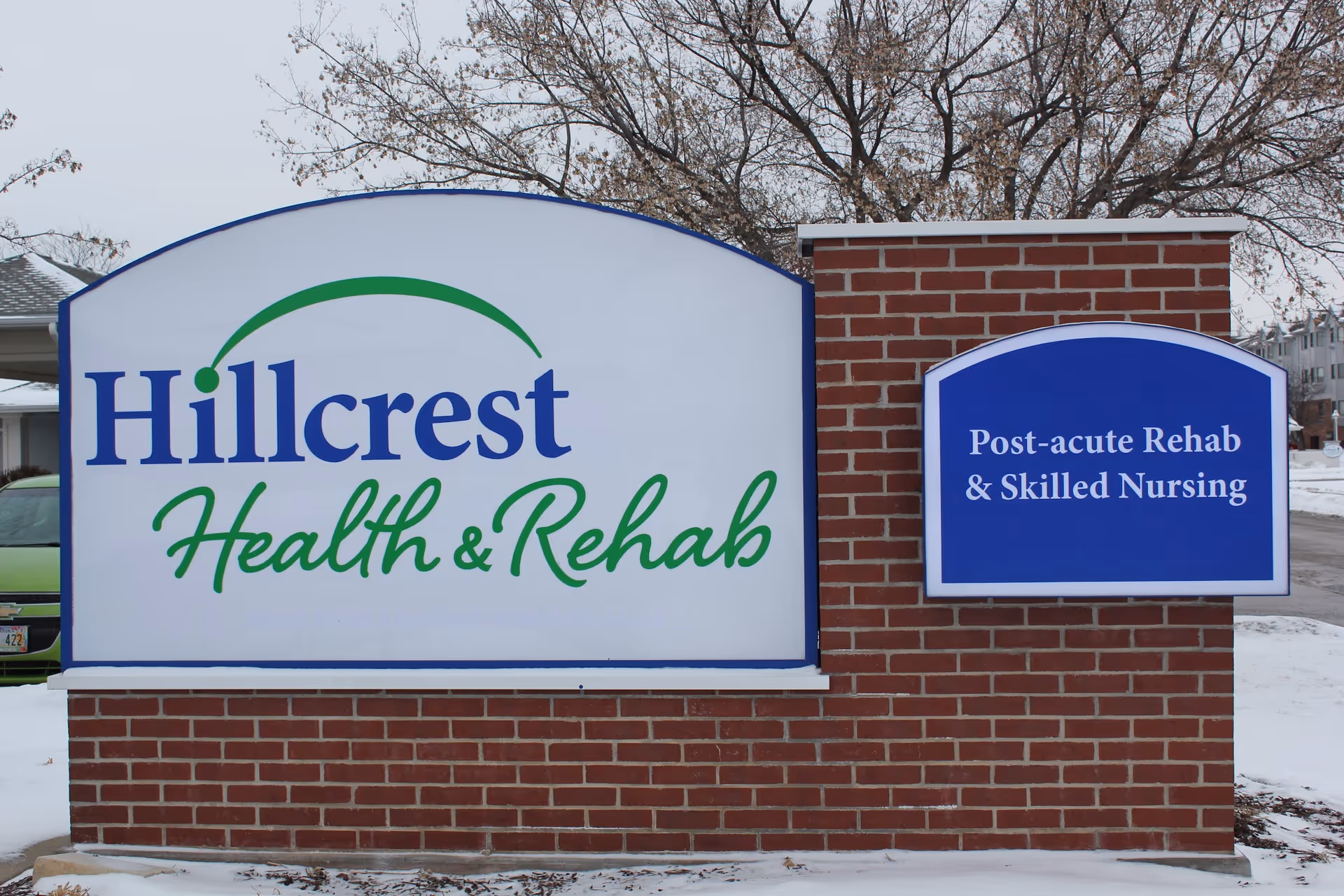 Brick sign outside Hillcrest Health & Rehab displaying Post-acute Rehab & Skilled Nursing