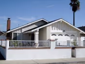 Single-story senior living facility exterior with front porch and railing.