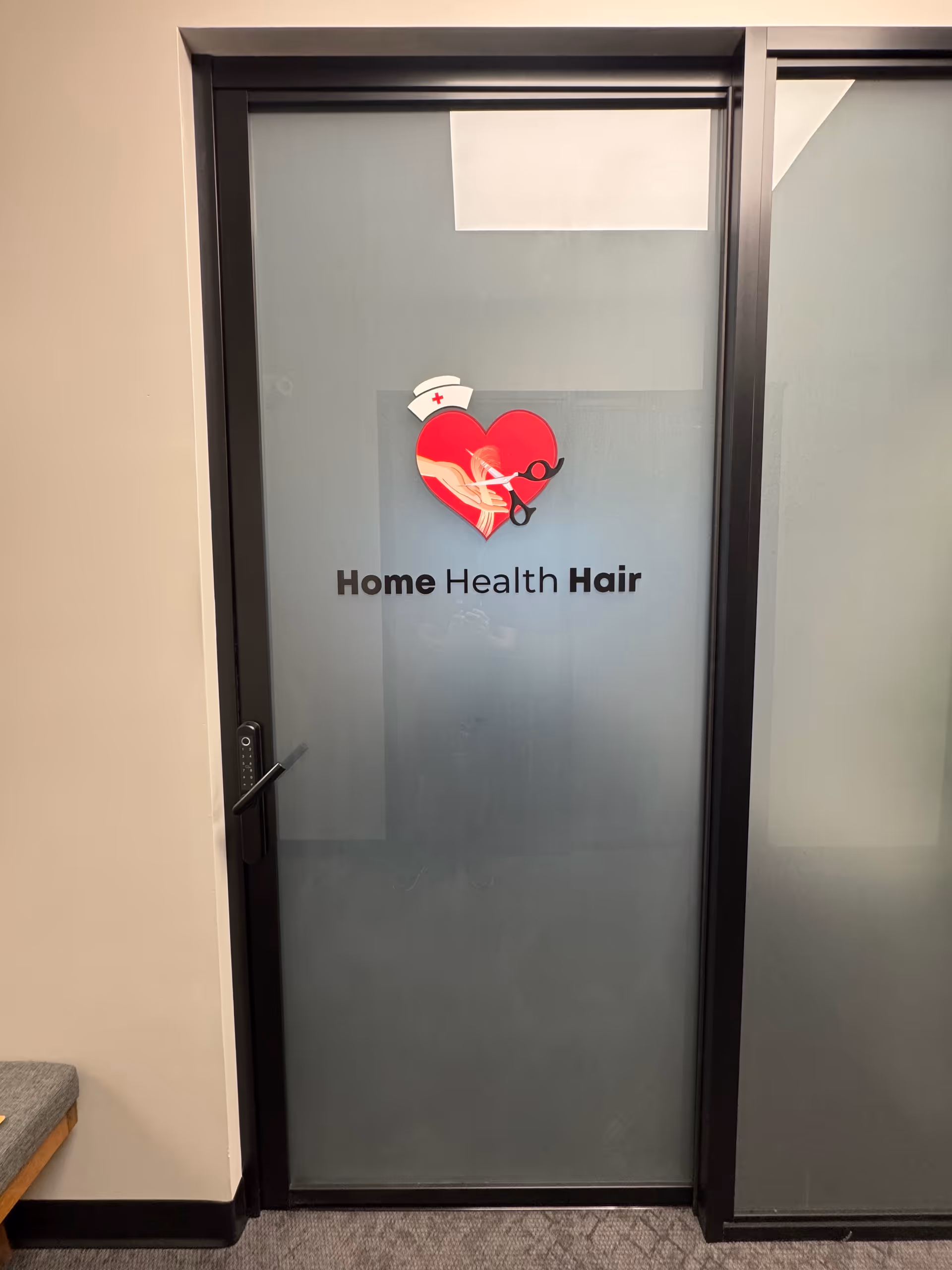 Frosted glass door displaying Home Health Hair logo with heart and stethoscope.