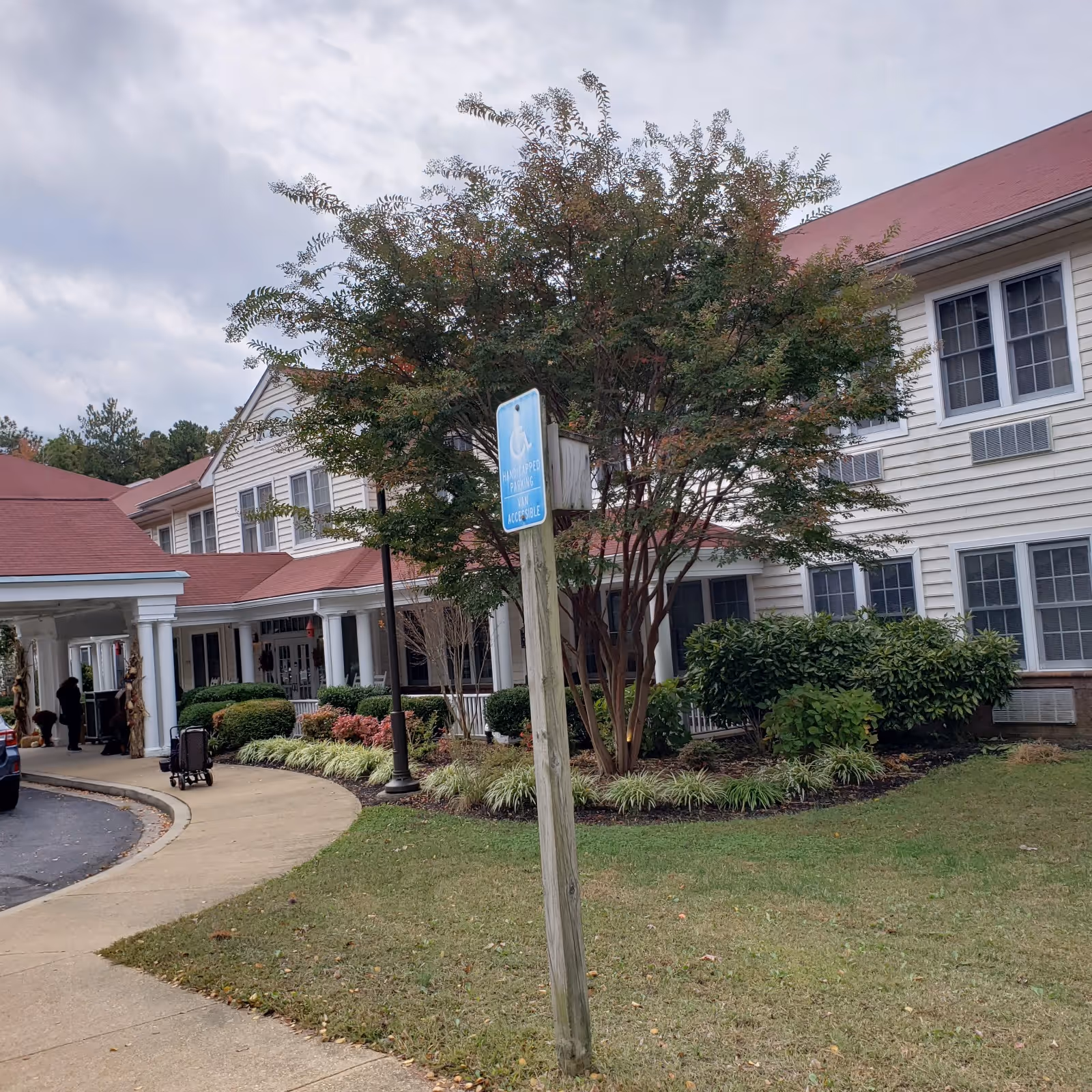 Exterior view of Hermitage at St. John's Creek with building entrance and landscaping.