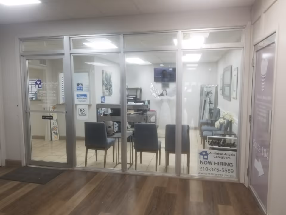 Glass-front reception area with seating and signs inside a senior care facility.