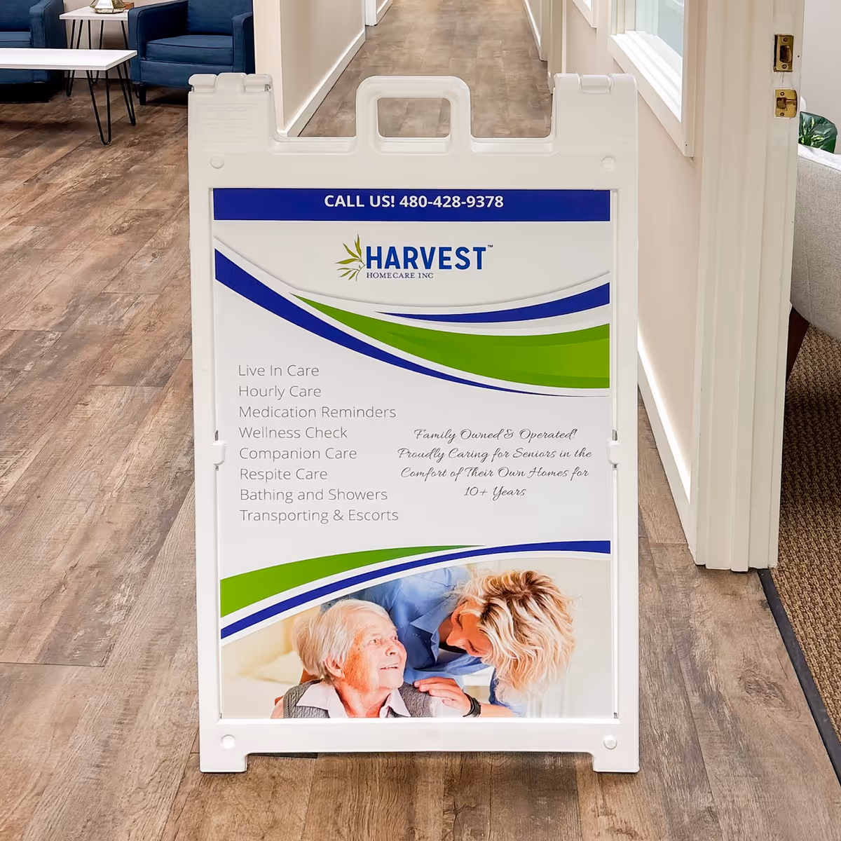 Indoor hallway with a large Harvest Homecare signboard and waiting area seating.