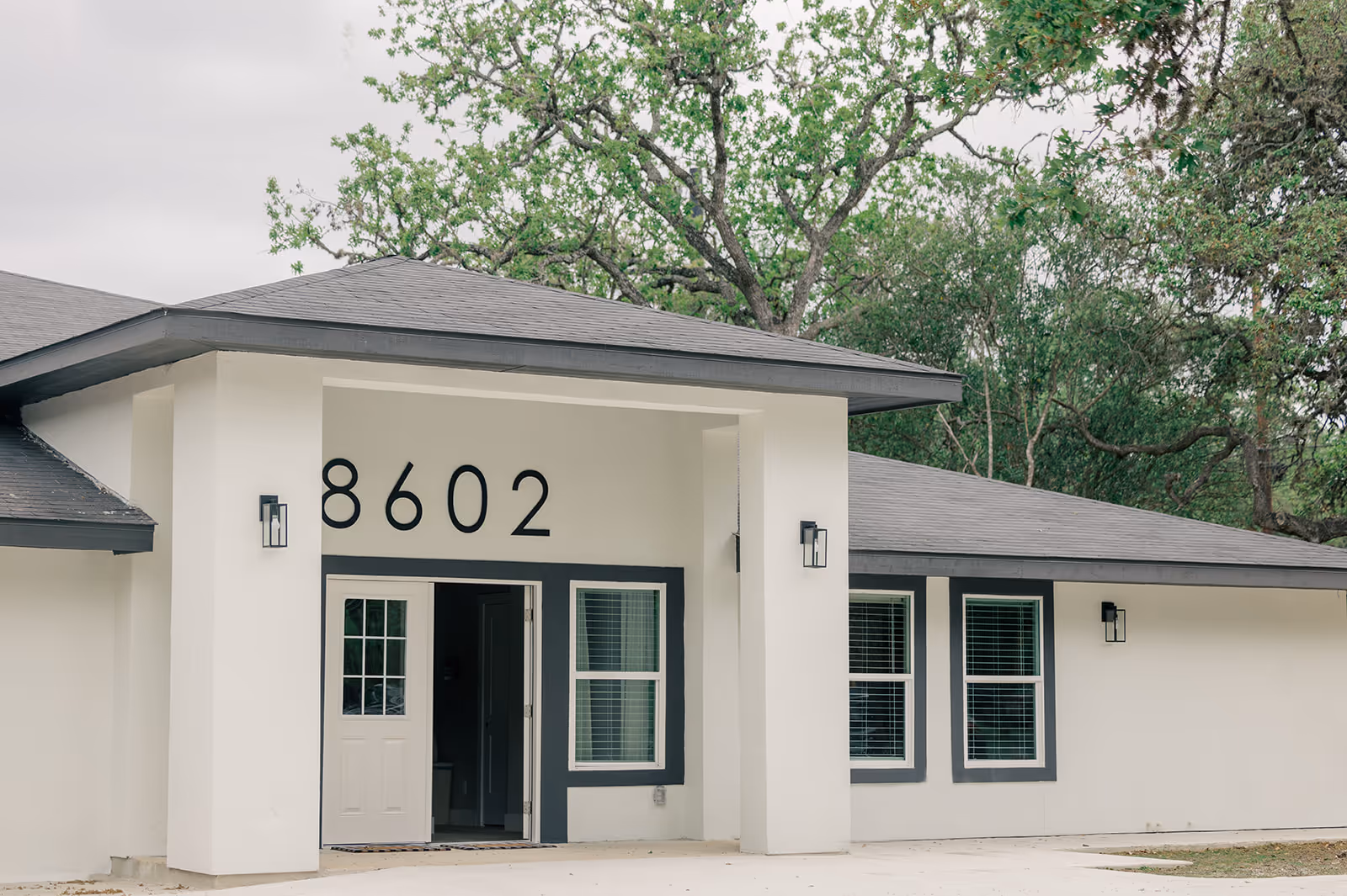 Modern senior living facility exterior with large entrance numbers.