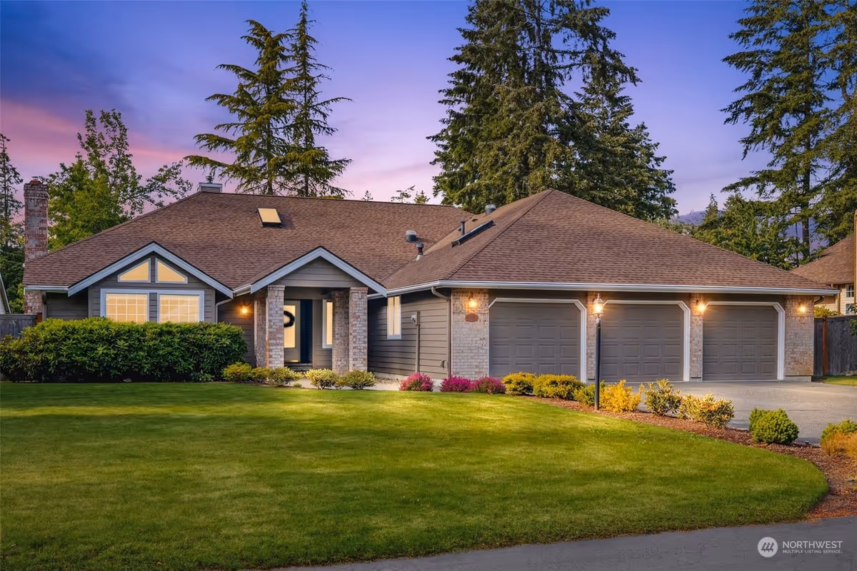 A single-story house-like senior living home with a manicured lawn and three garages.