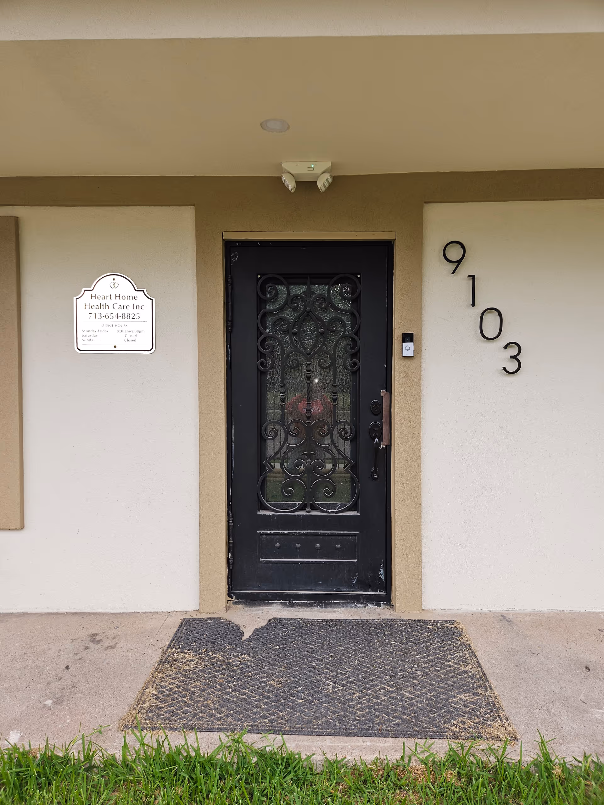 Front entrance of Heart Home Health Care Agency with ornate black door and the number 9103