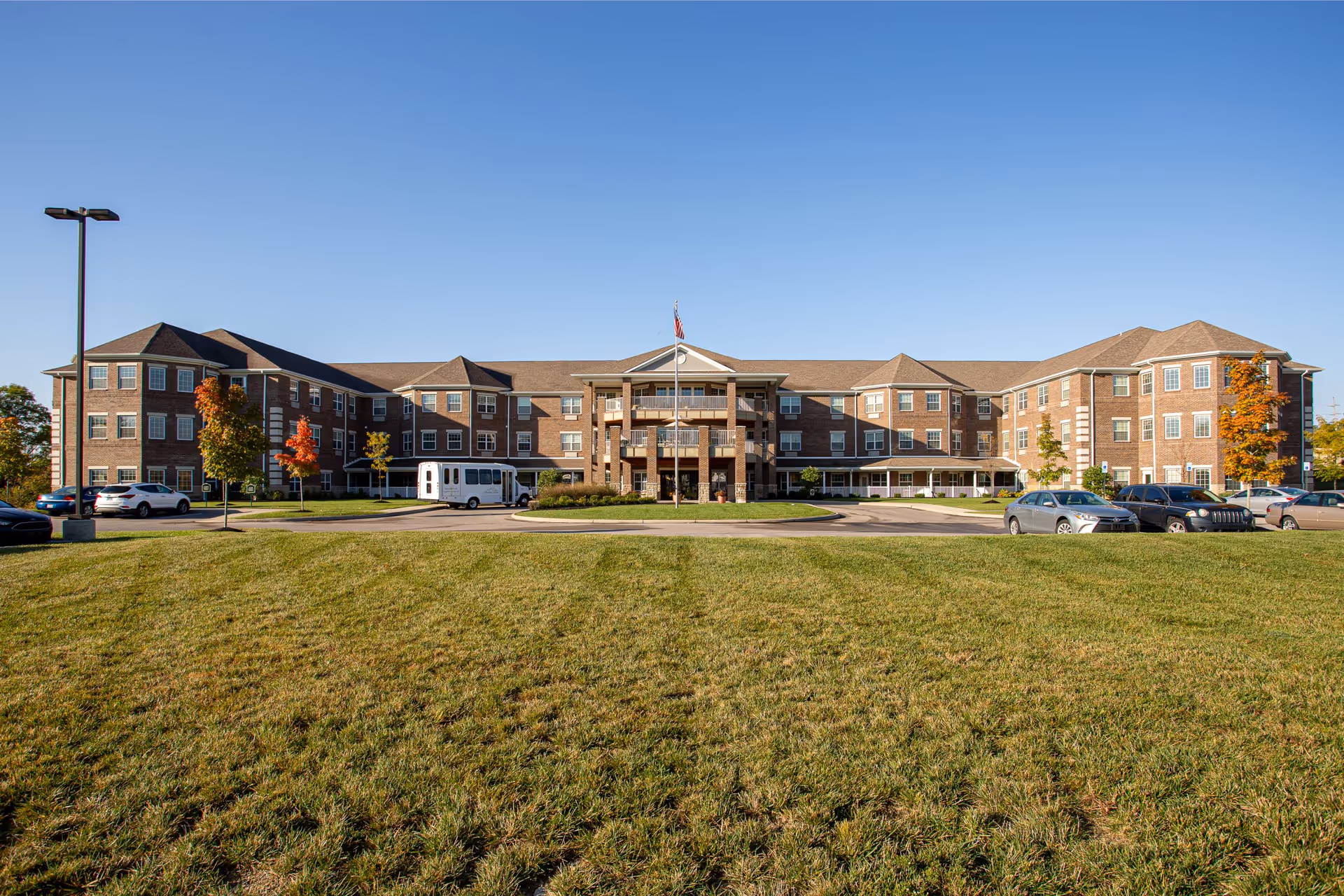 Wide view of Magnolia Springs Florence senior living facility exterior with a grassy foreground.