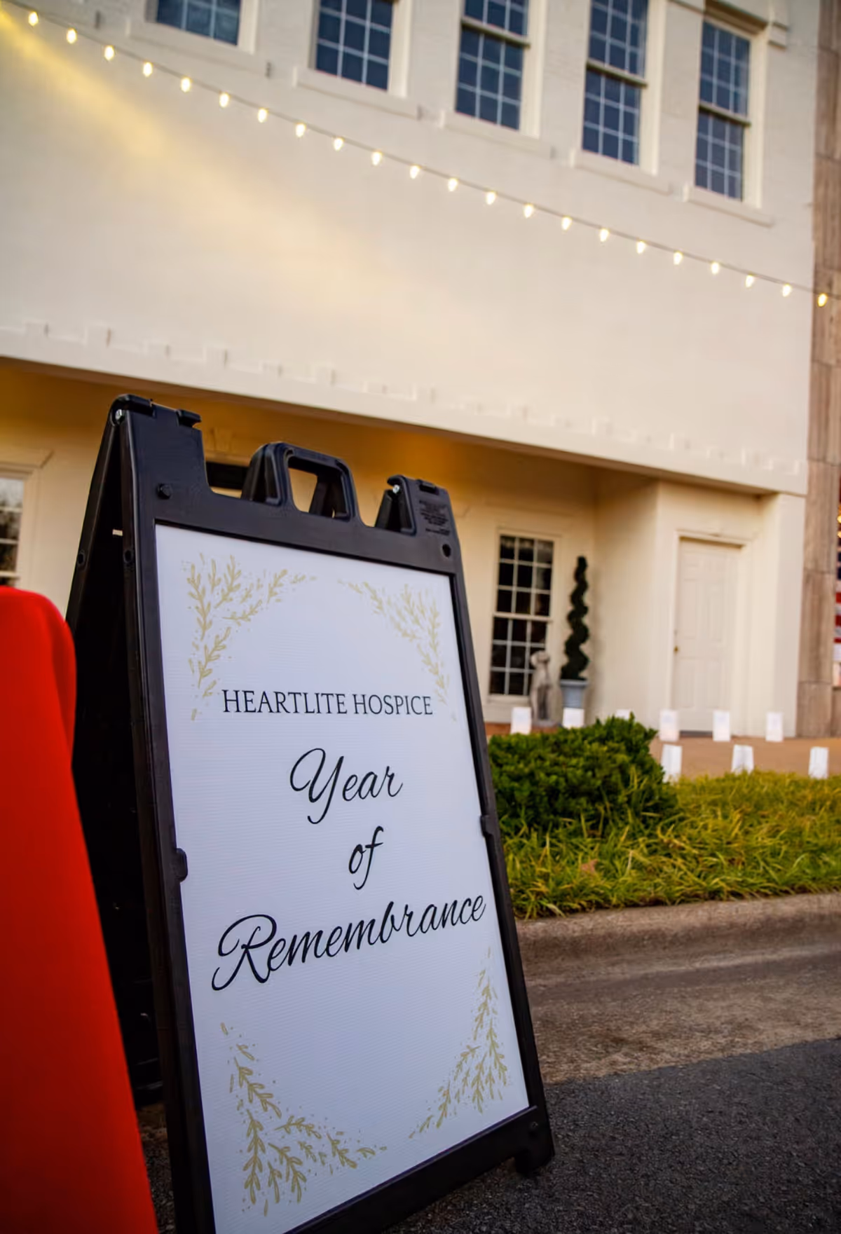 Exterior view of Heartlite Hospice Alabama with a Year of Remembrance signboard outside.