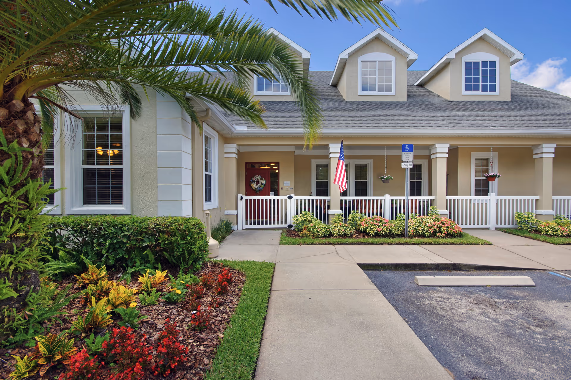 Front exterior of Brookdale Ormond Beach West, showing entrance and landscaped porch.