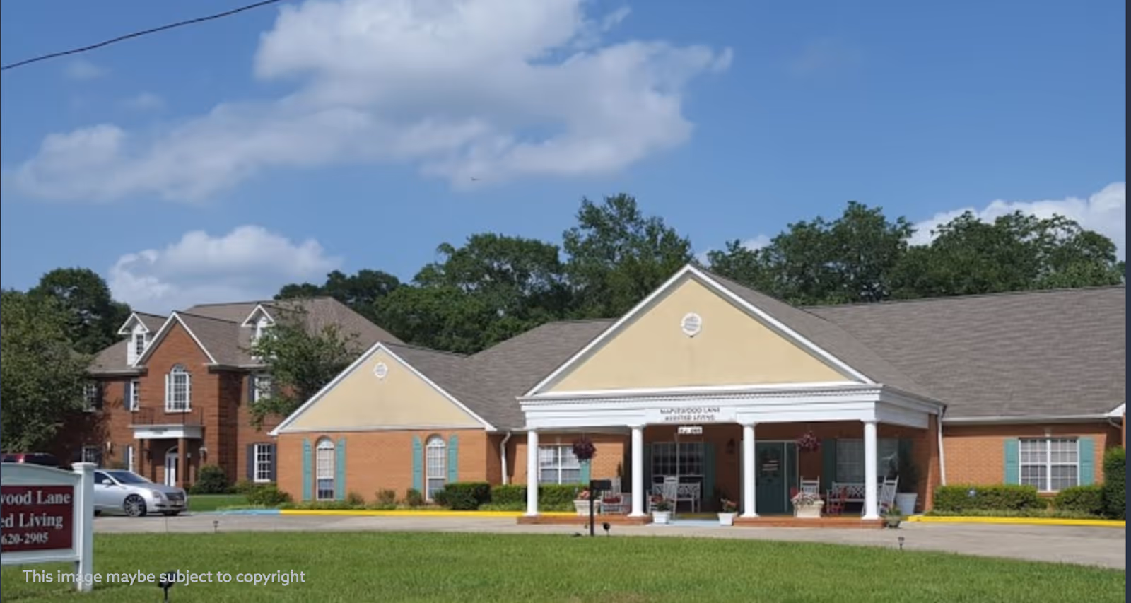 Front view of Maplewood Lane Assisted Living building with a covered entrance and white columns.