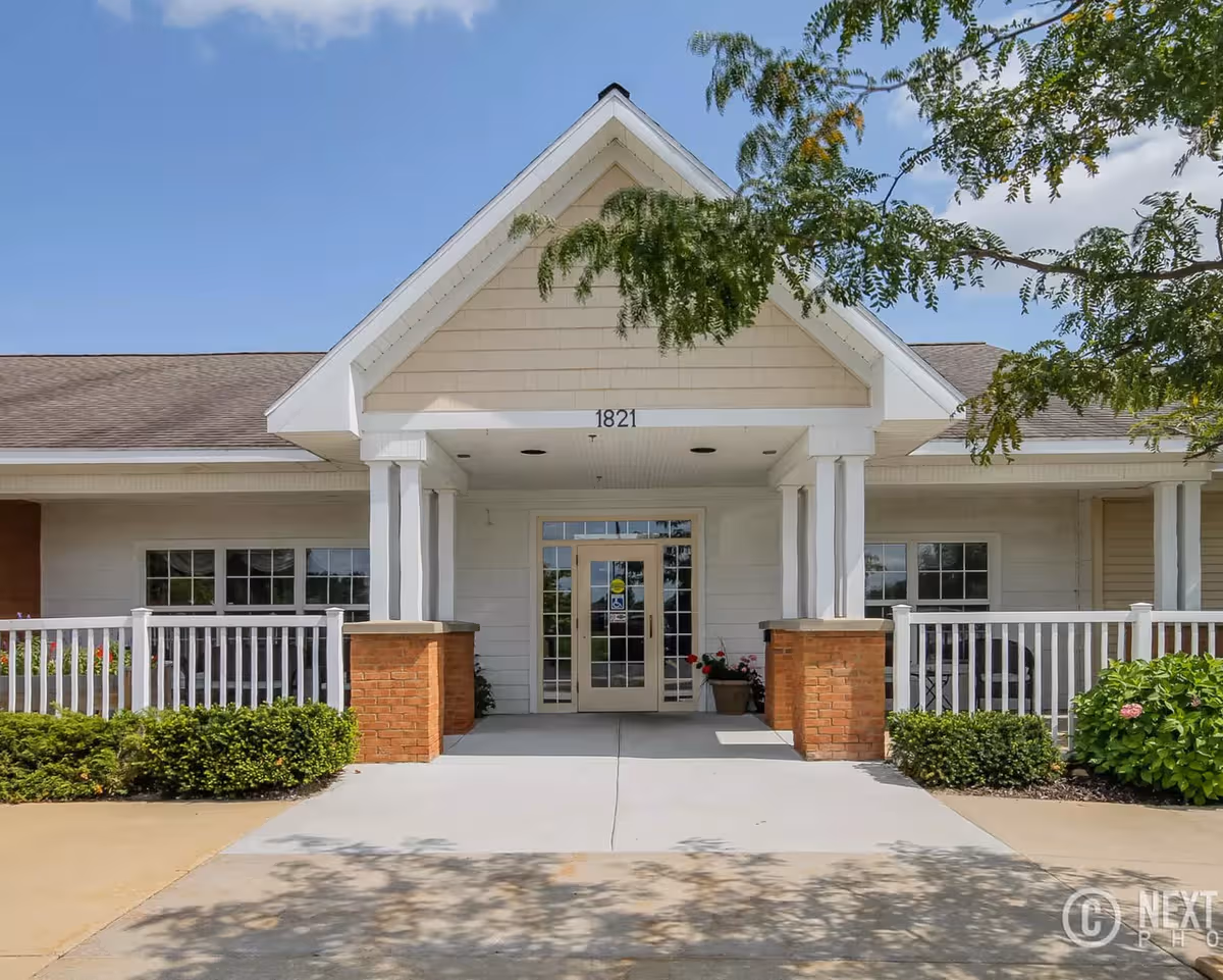 Woodlawn Meadows Assisted Living entrance with white columns and a covered porch.