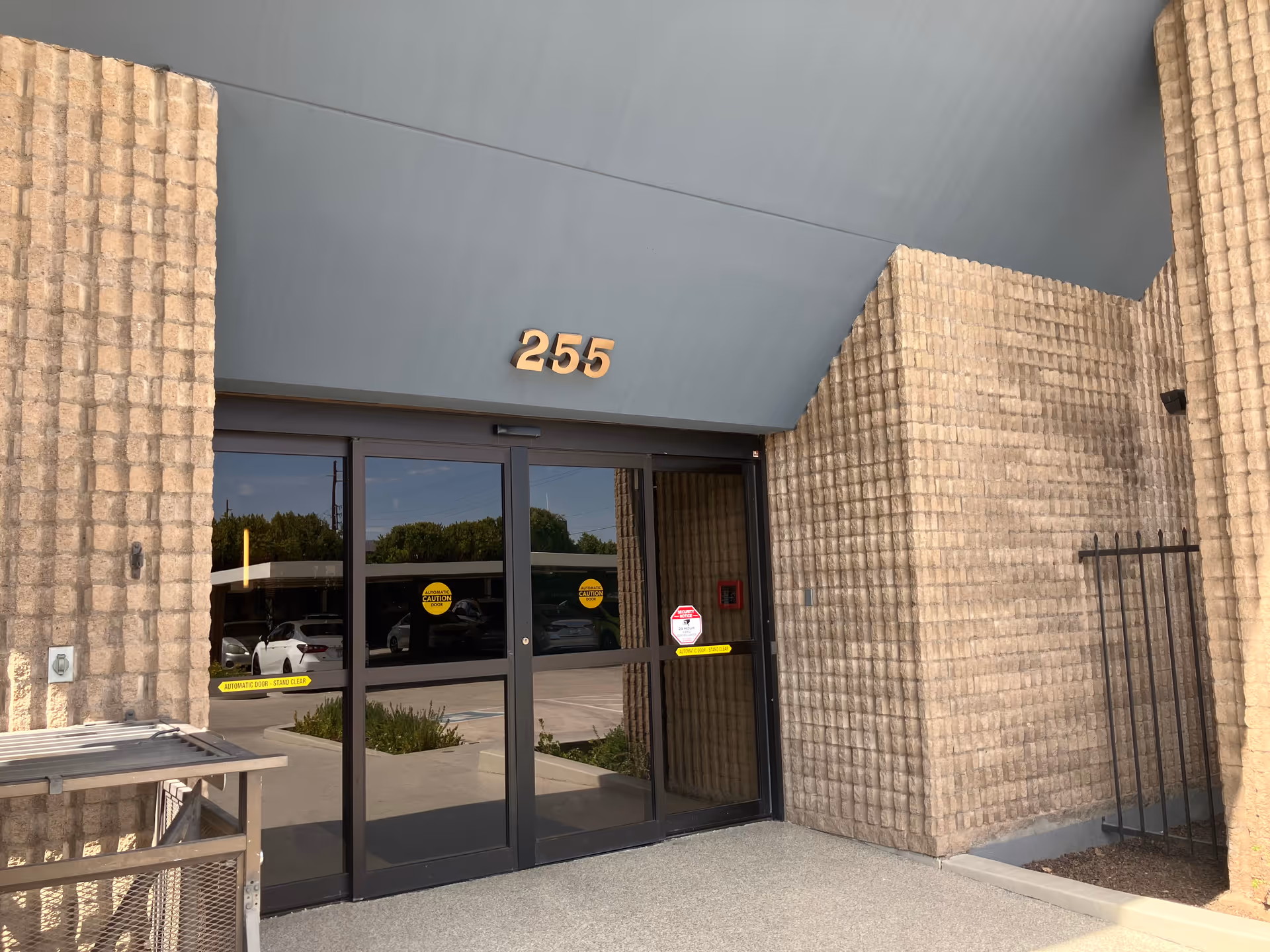 Exterior view of a senior living facility entrance with the number 255 on the facade.
