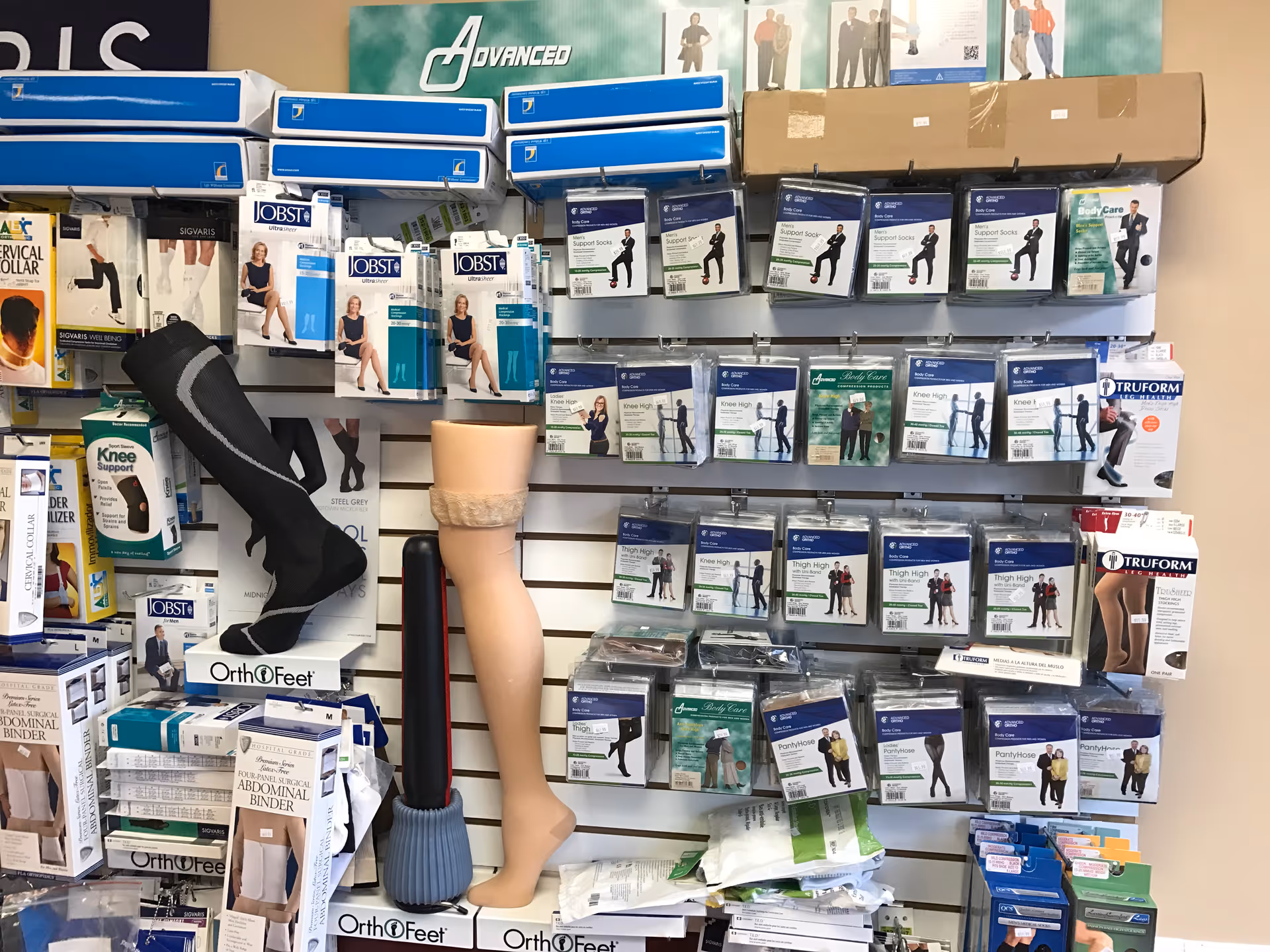 Interior display of medical support devices and prosthetic legs on shelves.