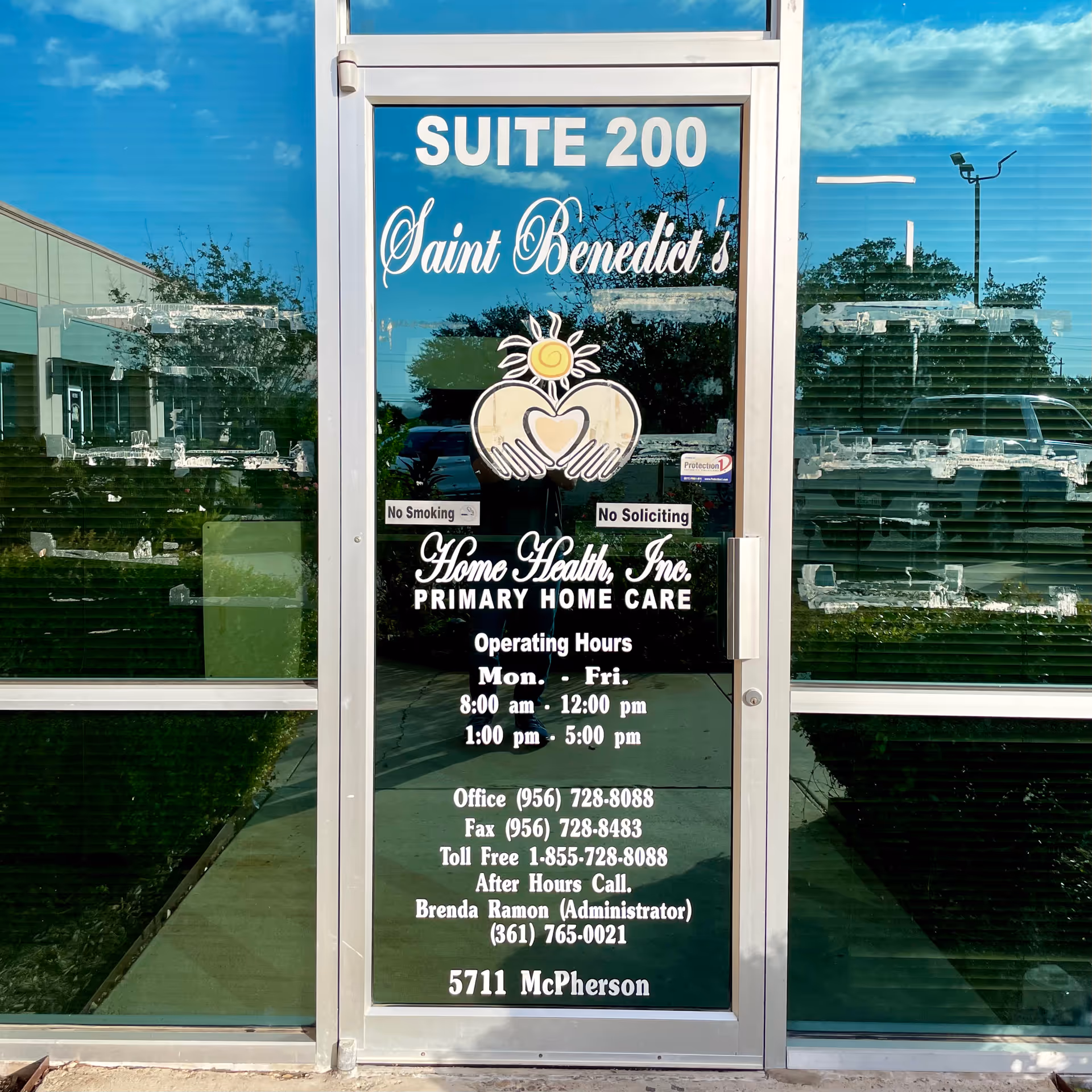 Glass entrance door displaying Suite 200 Saint Benedict's Home Health signage.