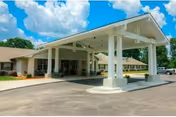 Front view of Spring Creek Health and Rehab entrance with a covered driveway.