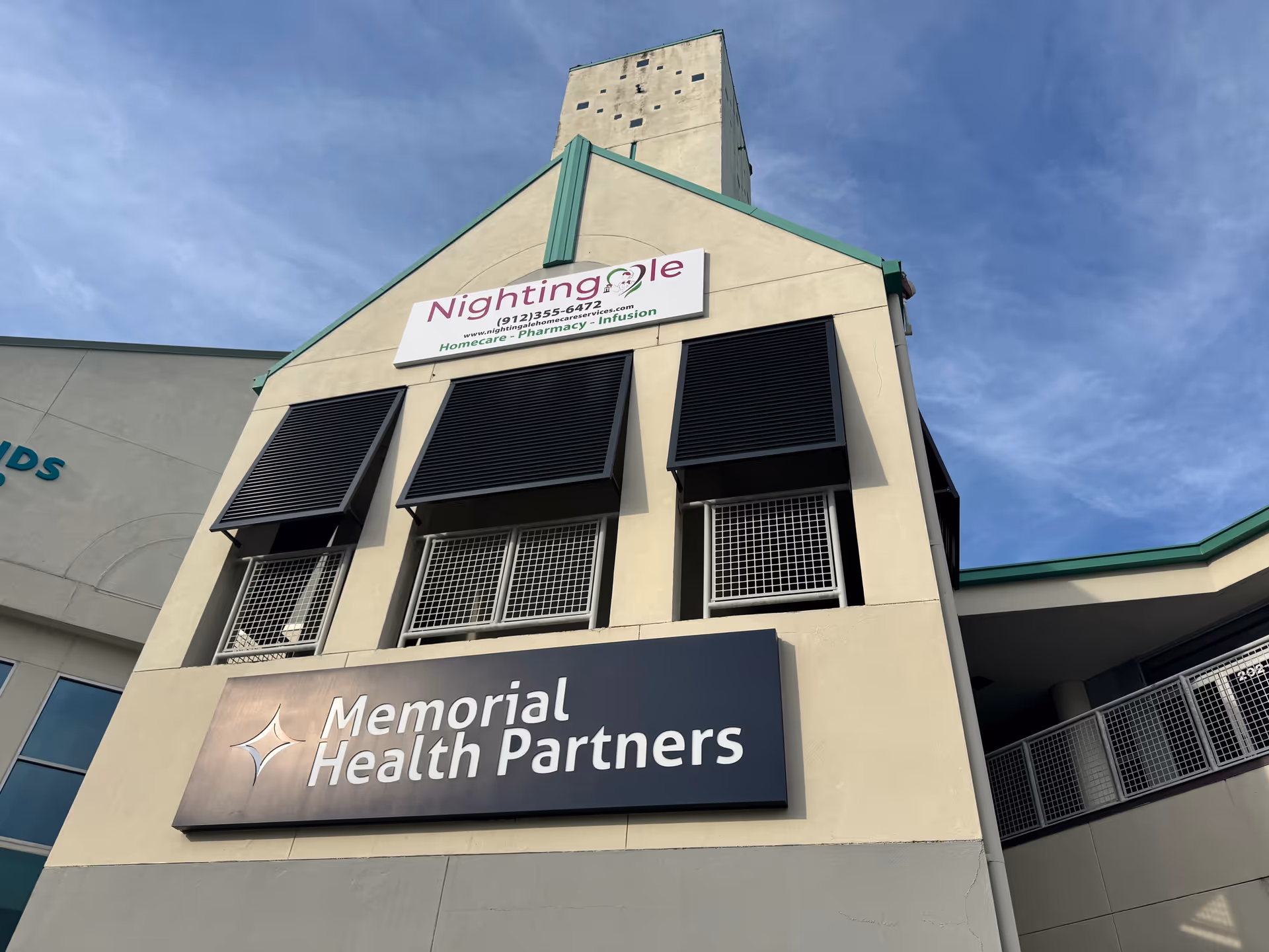 Front exterior of a building with Nightingale sign and Memorial Health Partners sign.