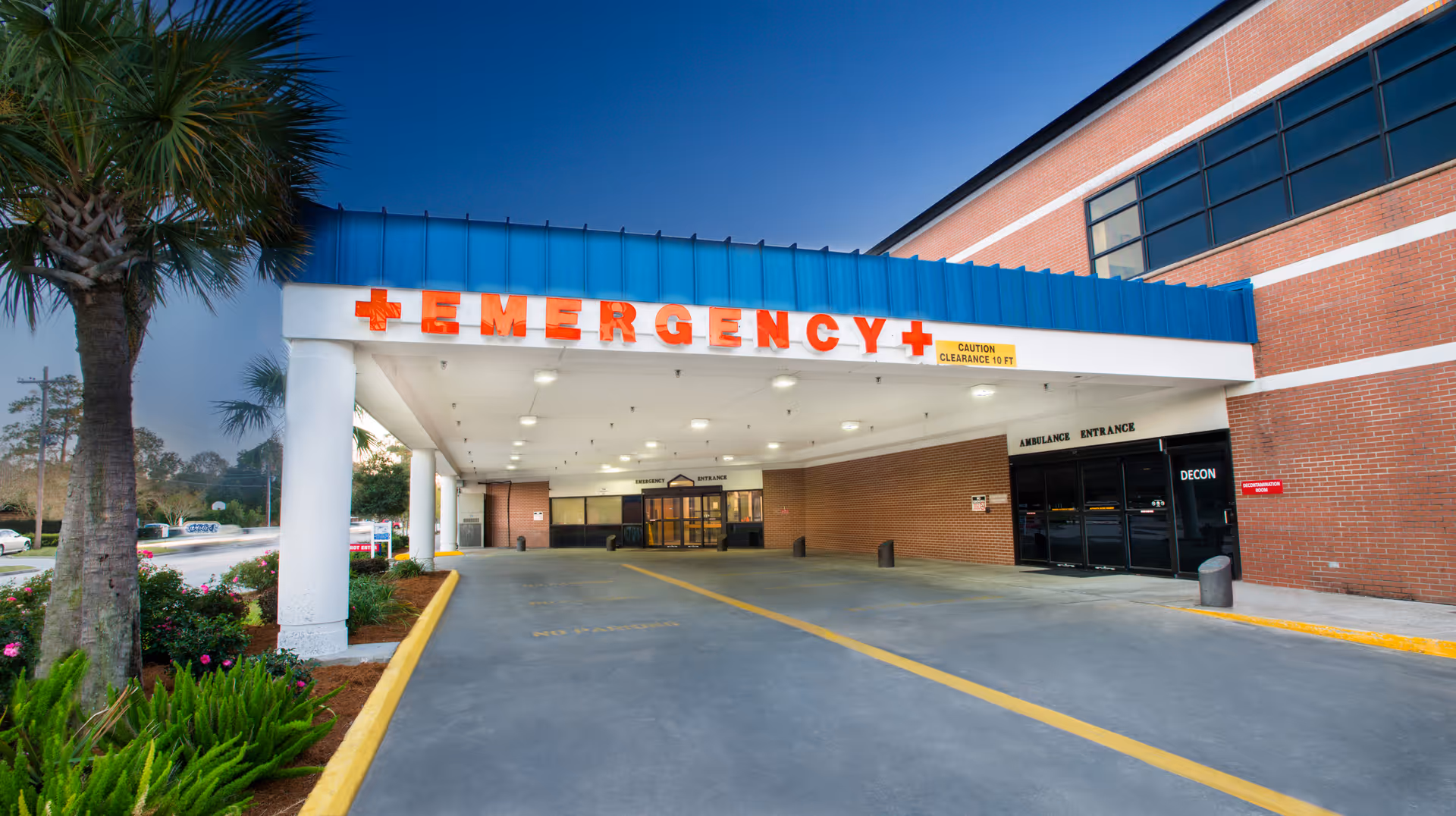 Exterior view of West Calcasieu Cameron Hospital emergency entrance with a blue canopy.