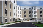 Exterior view of Christopher Heights of Worcester, a multi-story beige senior living building.