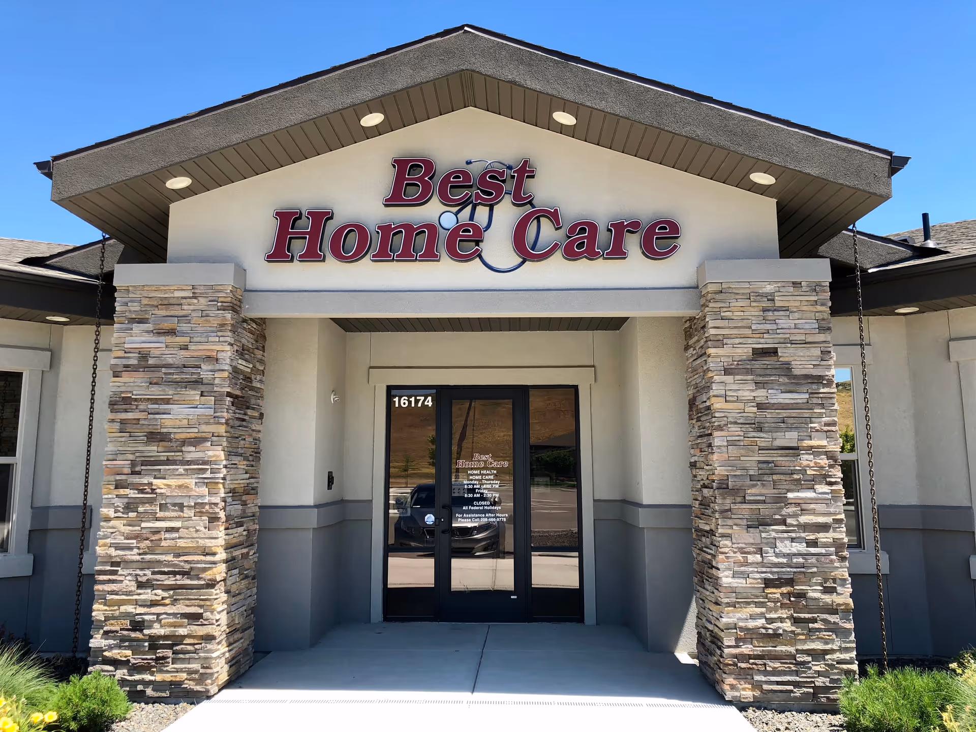 Entrance to a facility named Best Home Care with stone columns and glass doors