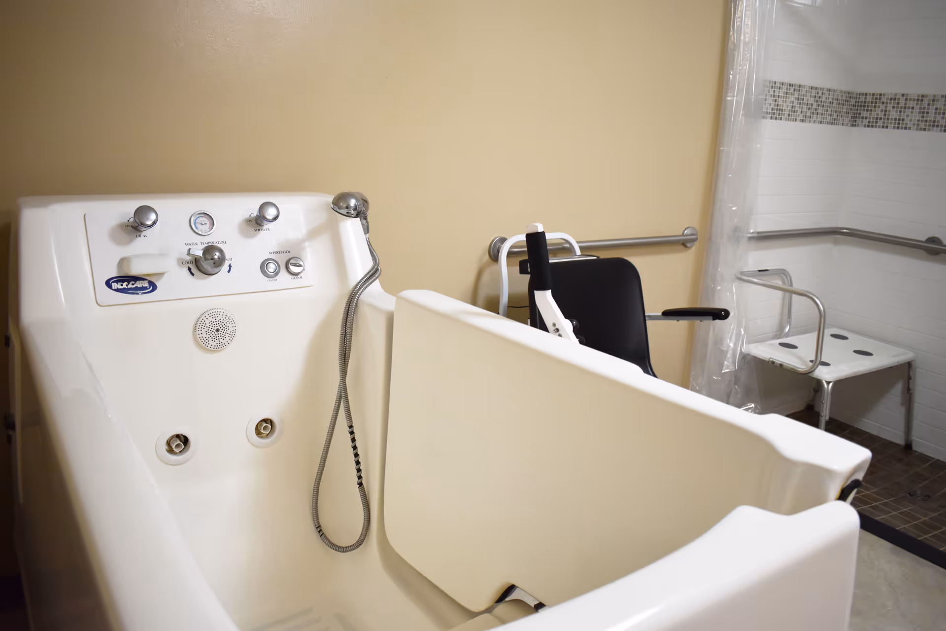 Accessible bathroom with a tub lift, chair, and grab bars.