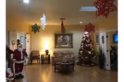 A cozy common living room with Christmas tree and holiday decorations.