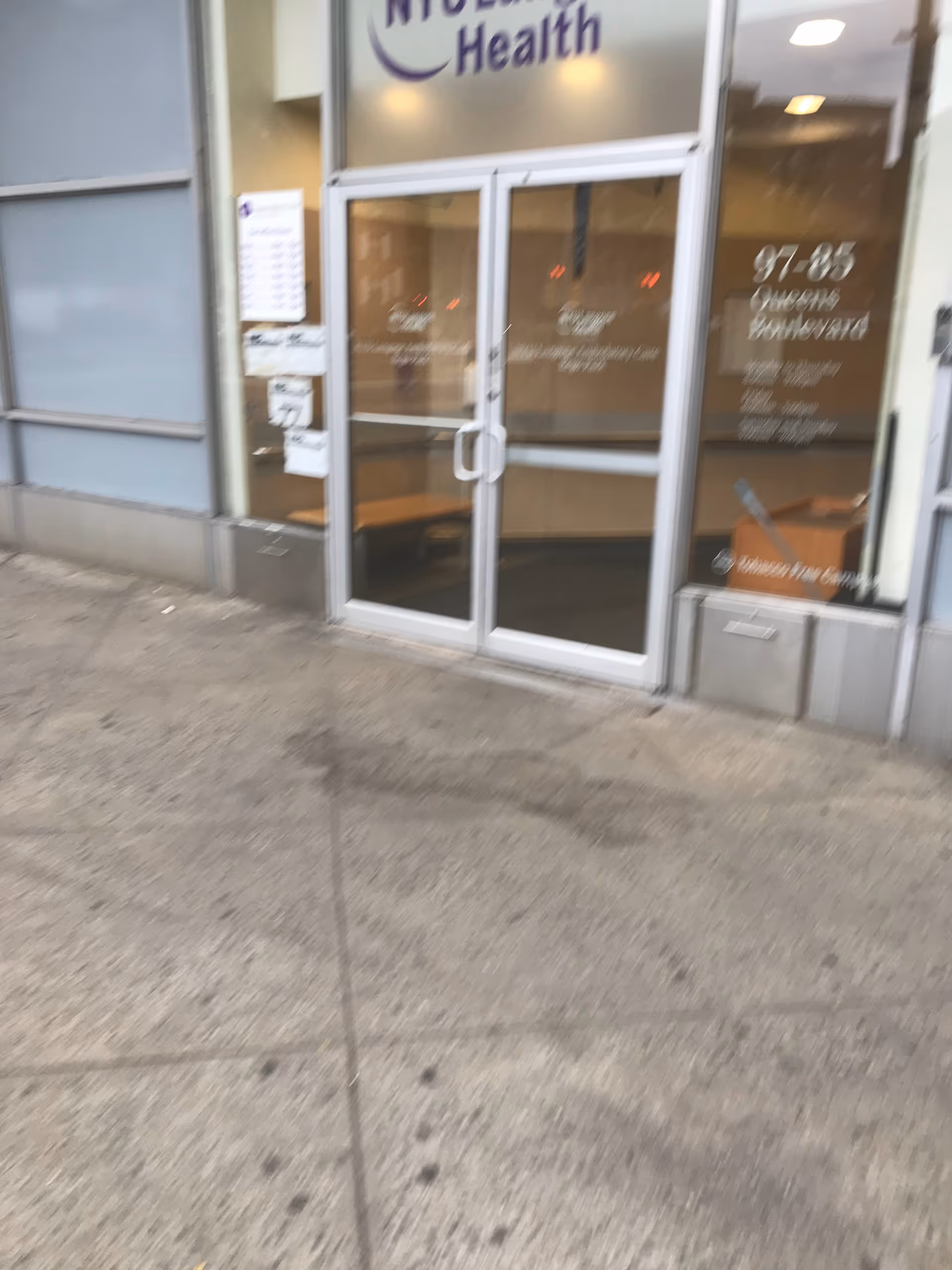 Exterior glass doors with NYU Langone Health signage at the building entrance.