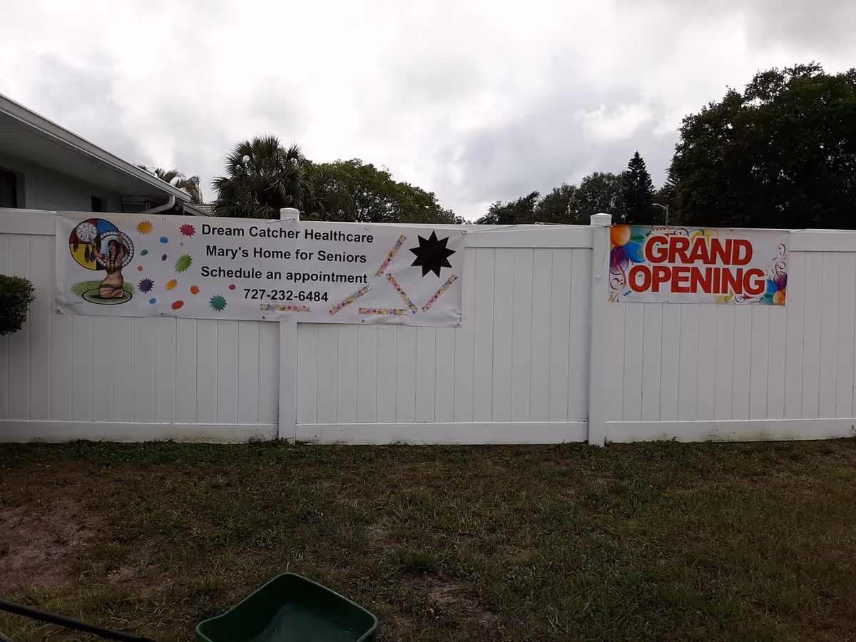 White fence with banners for Dream Catcher Healthcare Mary’s Home for Elders Grand Opening.