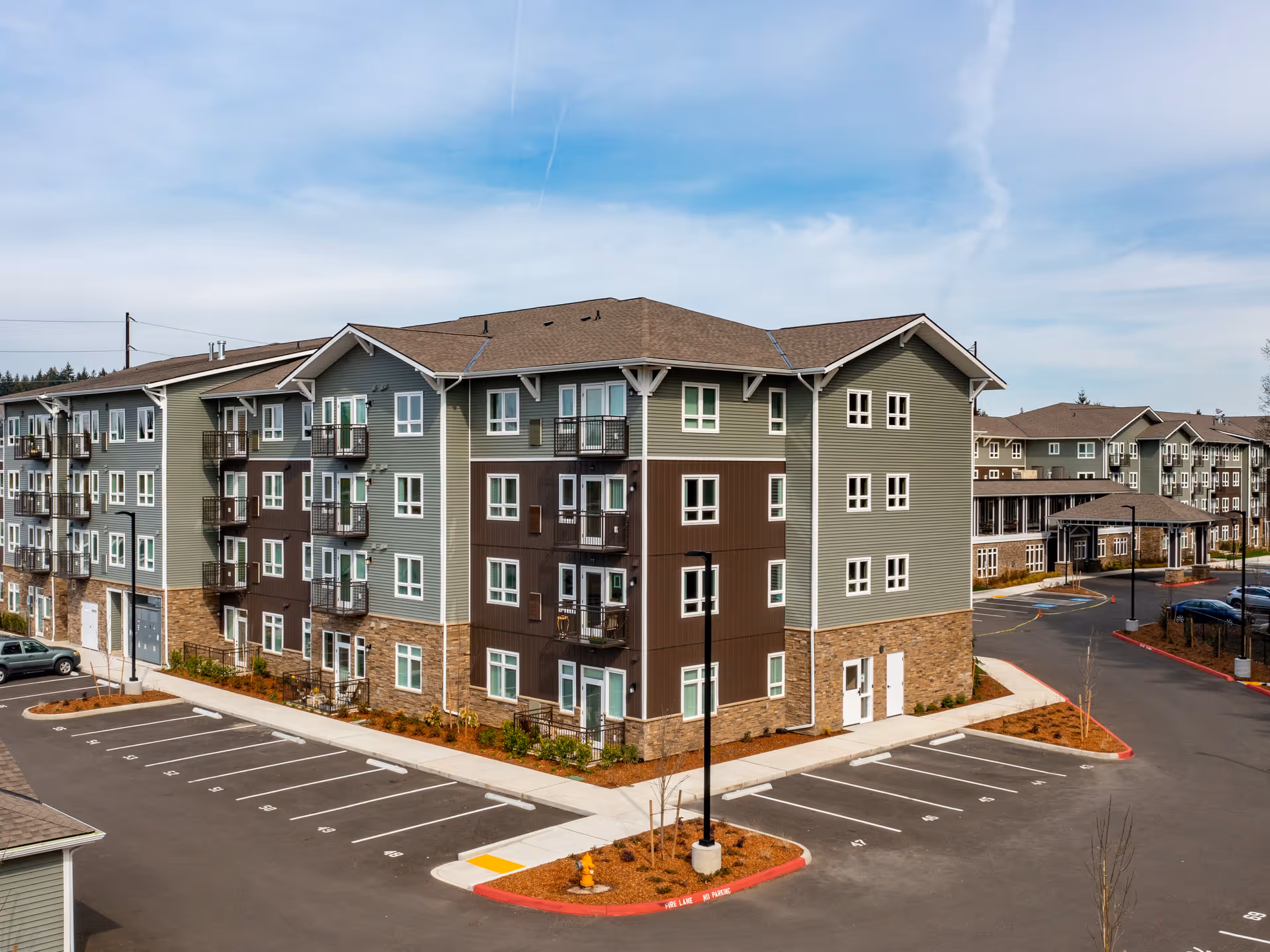 Exterior view of Affinity at Vancouver residential building with parking lots and entrances.