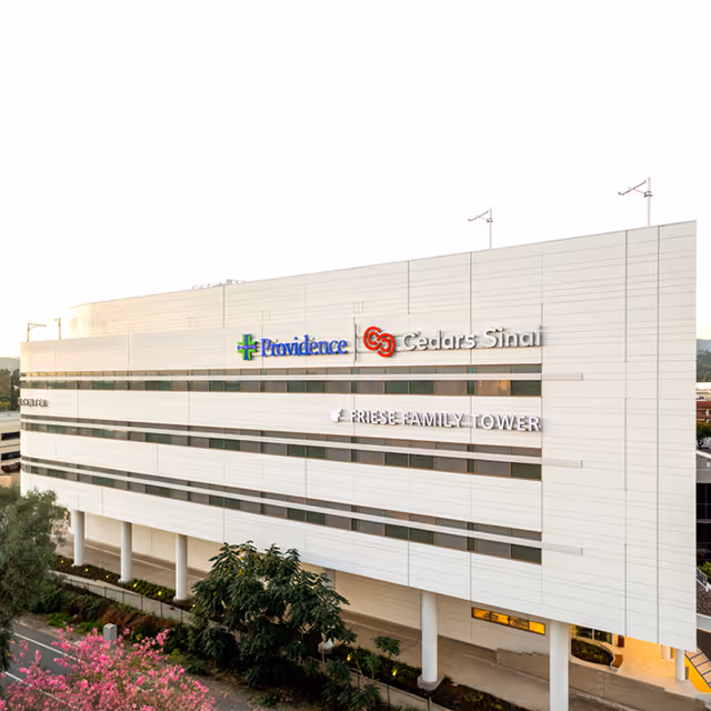 Exterior view of Providence Home Care - Tarzana facility, a white multi-story building with signage.