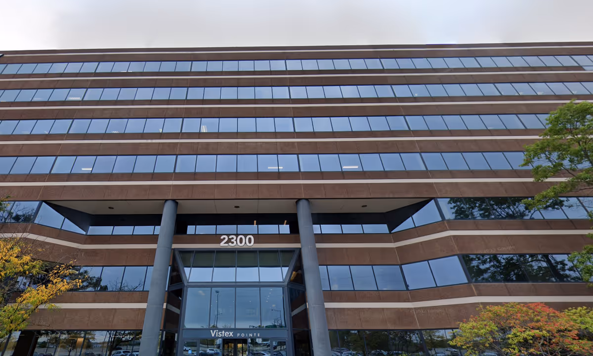 Exterior view of a modern brick-and-glass building entrance labeled 2300.