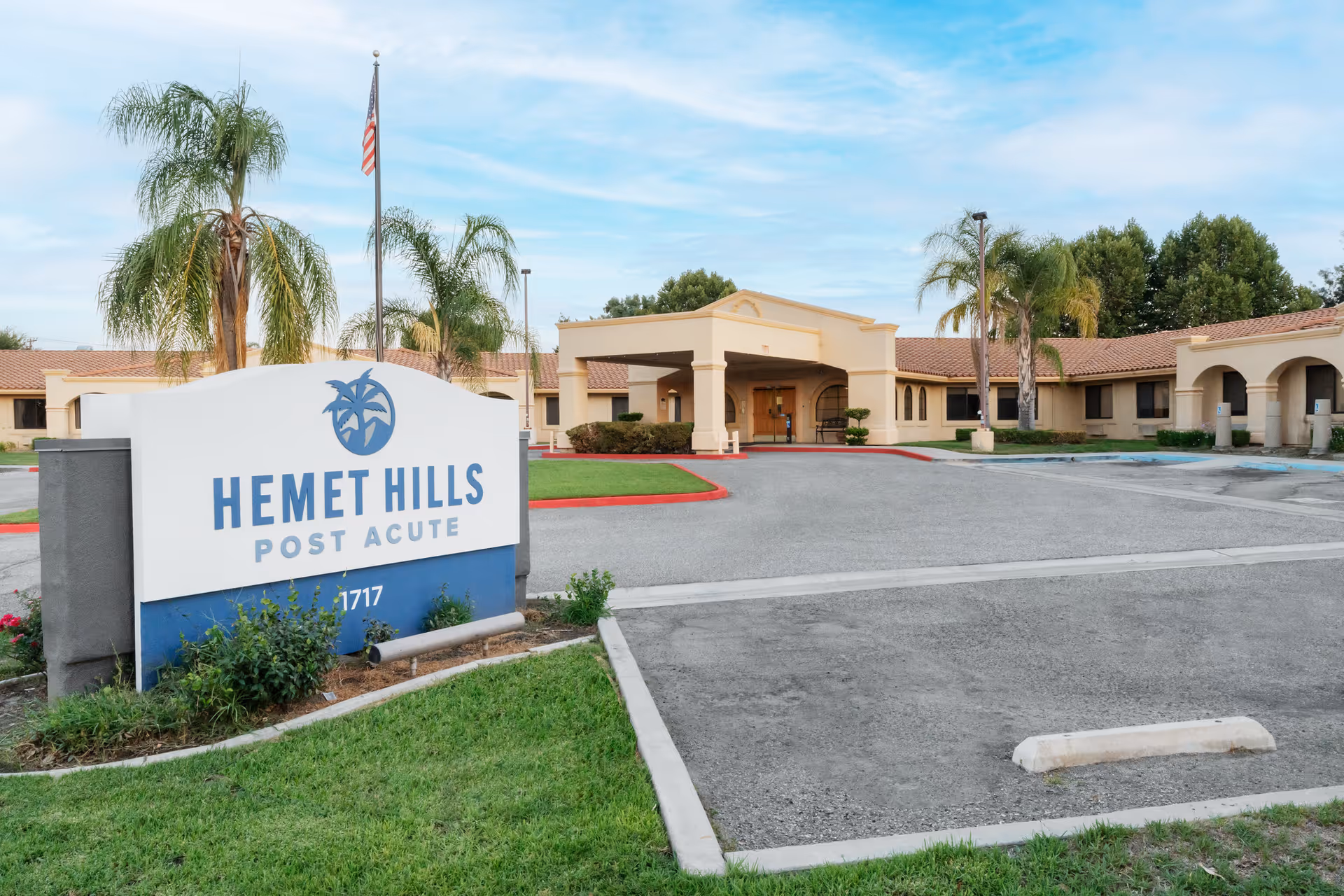 Exterior view of Hemet Hills Post Acute facility with sign and palm trees