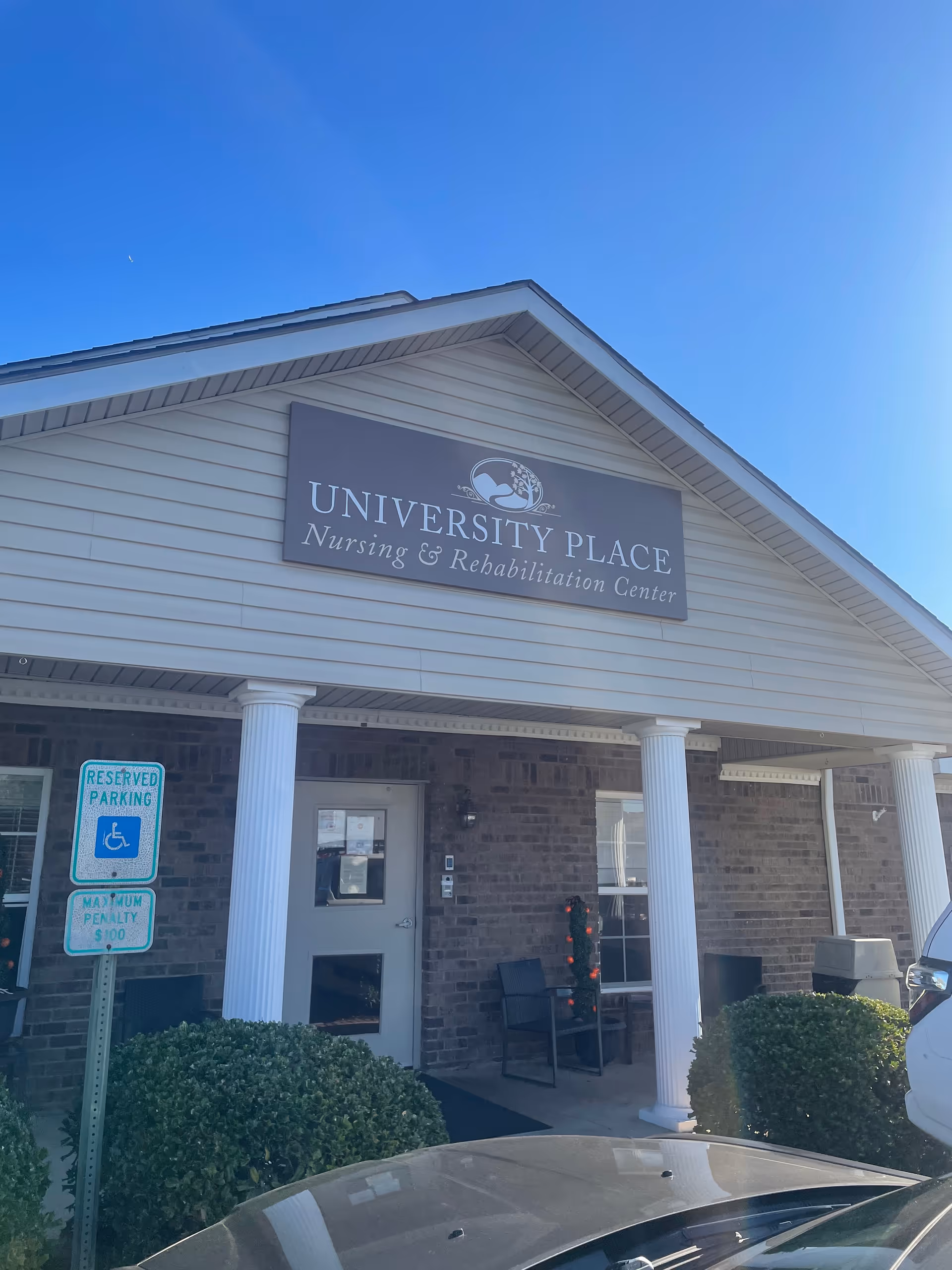 Front view of University Place Nursing and Rehabilitation Center with brick exterior and sign.