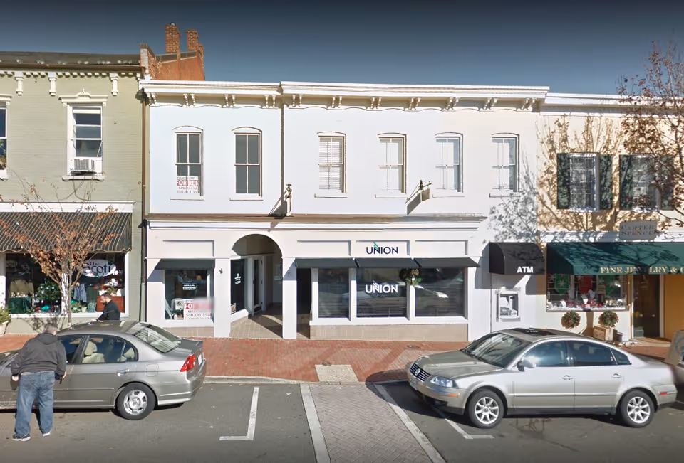 Front view of a white storefront building with a Union sign