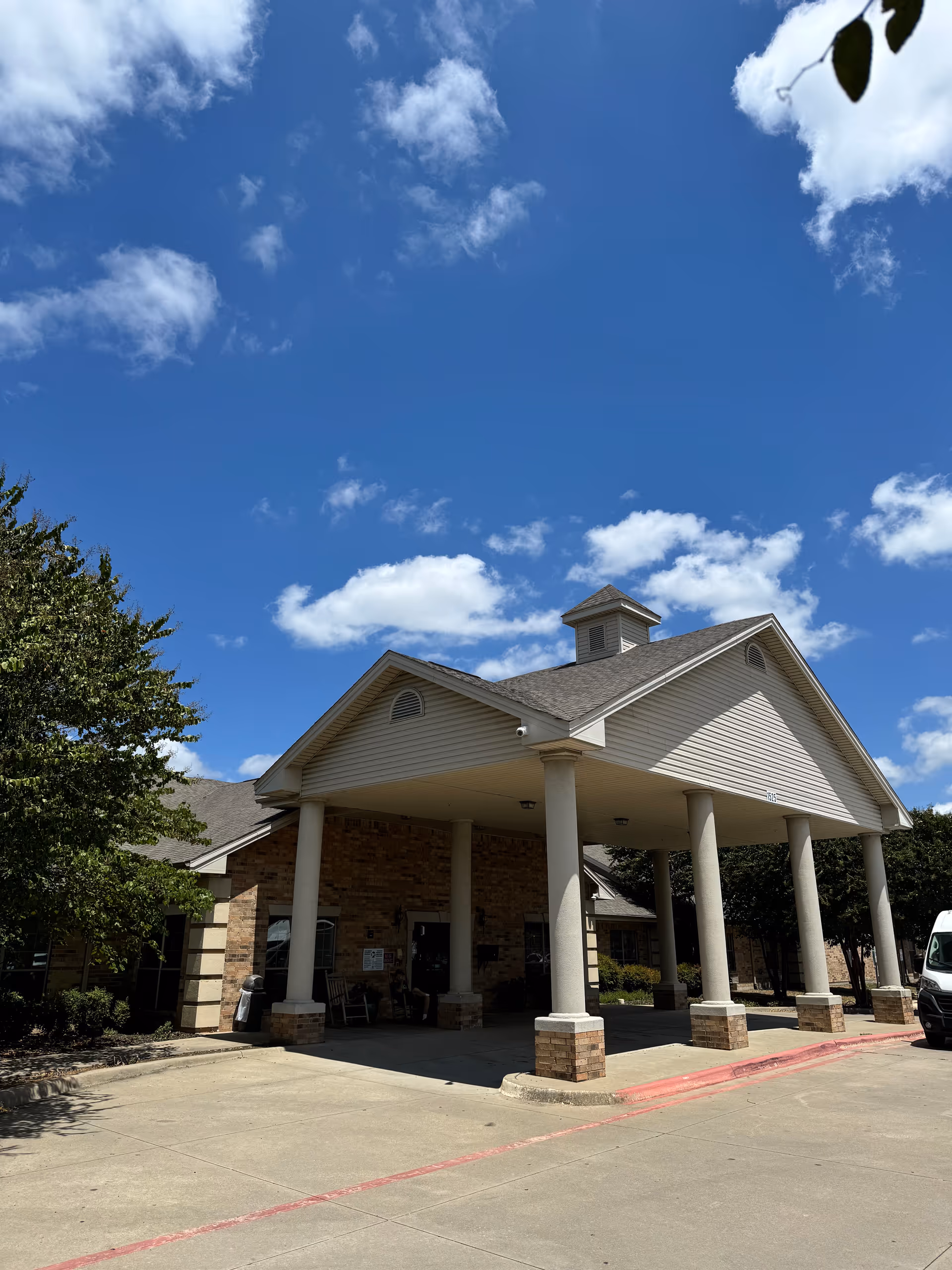 Front view of Pleasant Valley Healthcare Rehabilitation Center with a covered entrance and columns.