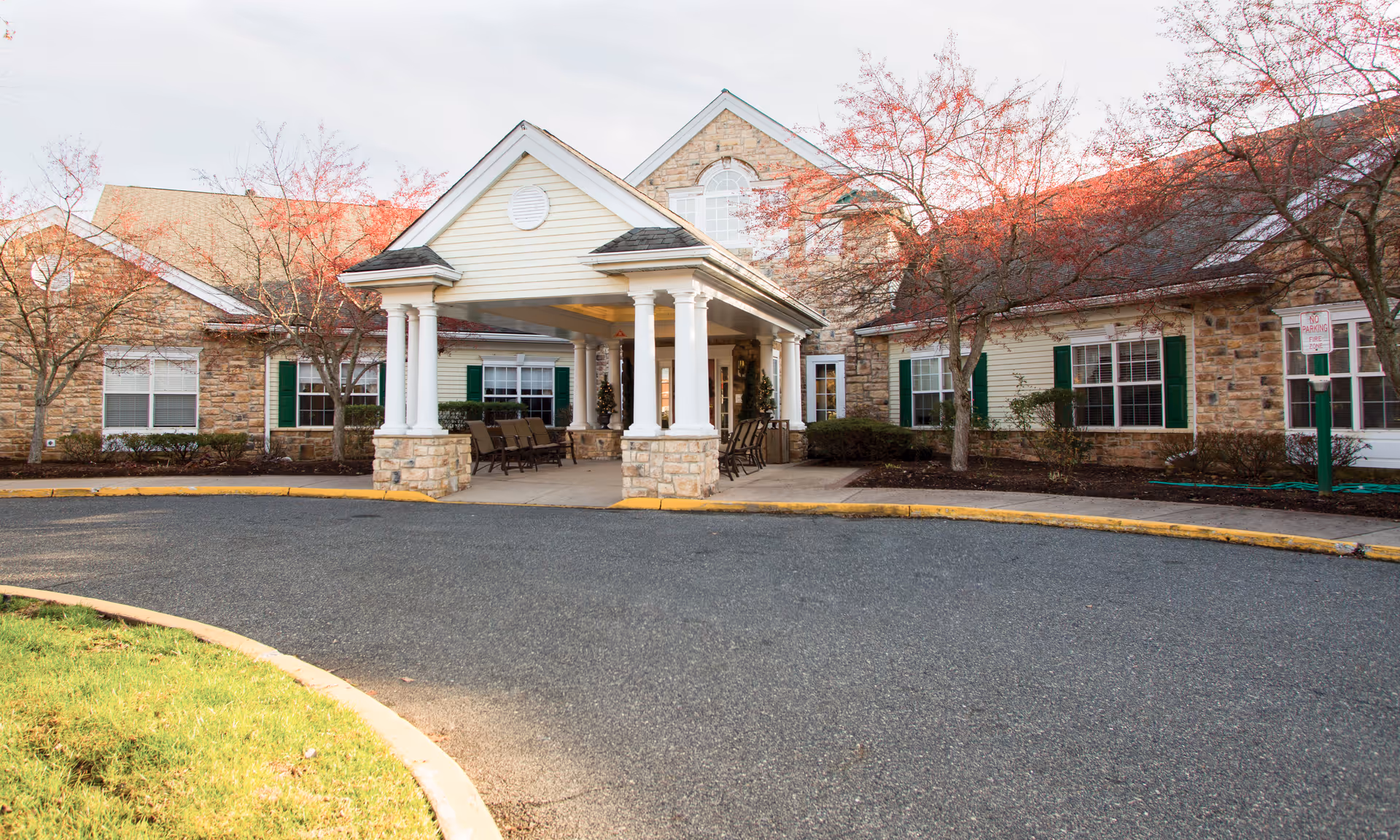 Front exterior of Brookdale Westampton senior living facility with a covered entrance and seating