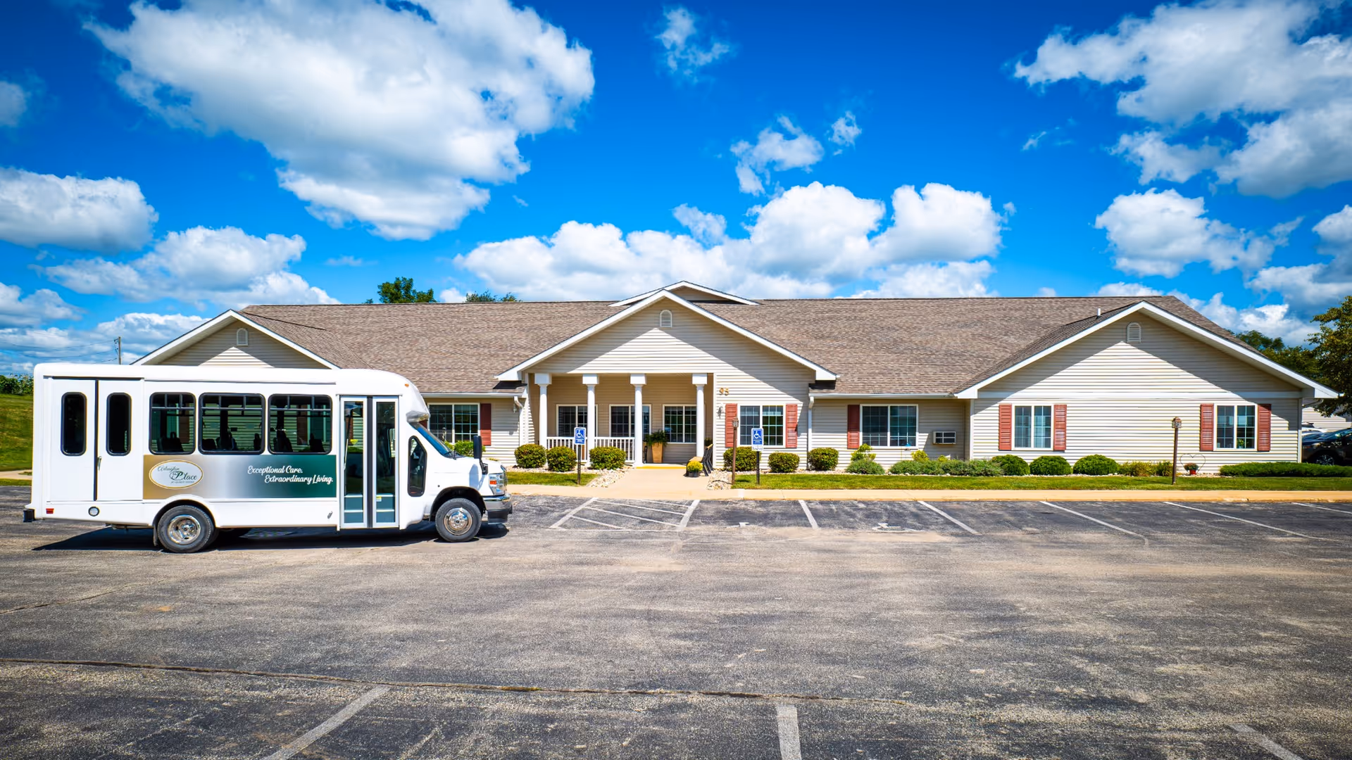 Front view of Arlington Place at Grundy Center with a shuttle bus parked outside