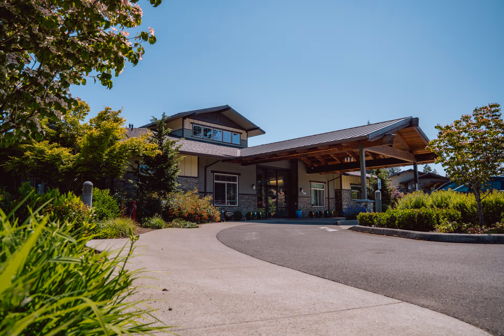 Front exterior view of Fieldstone Memory Care Olympia with a covered entrance and landscaping.