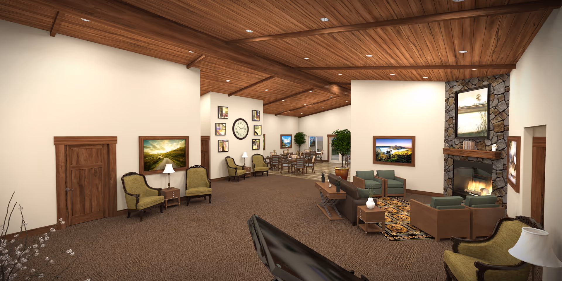 A spacious and warmly lit common area in an assisted living facility featuring a seating area with green and brown armchairs and sofas arranged around a stone fireplace with a fire burning. The room has a wooden ceiling with recessed lighting, framed landscape pictures on the walls, a large clock, and a dining area with tables and chairs in the background. There are also potted plants and side tables with lamps.