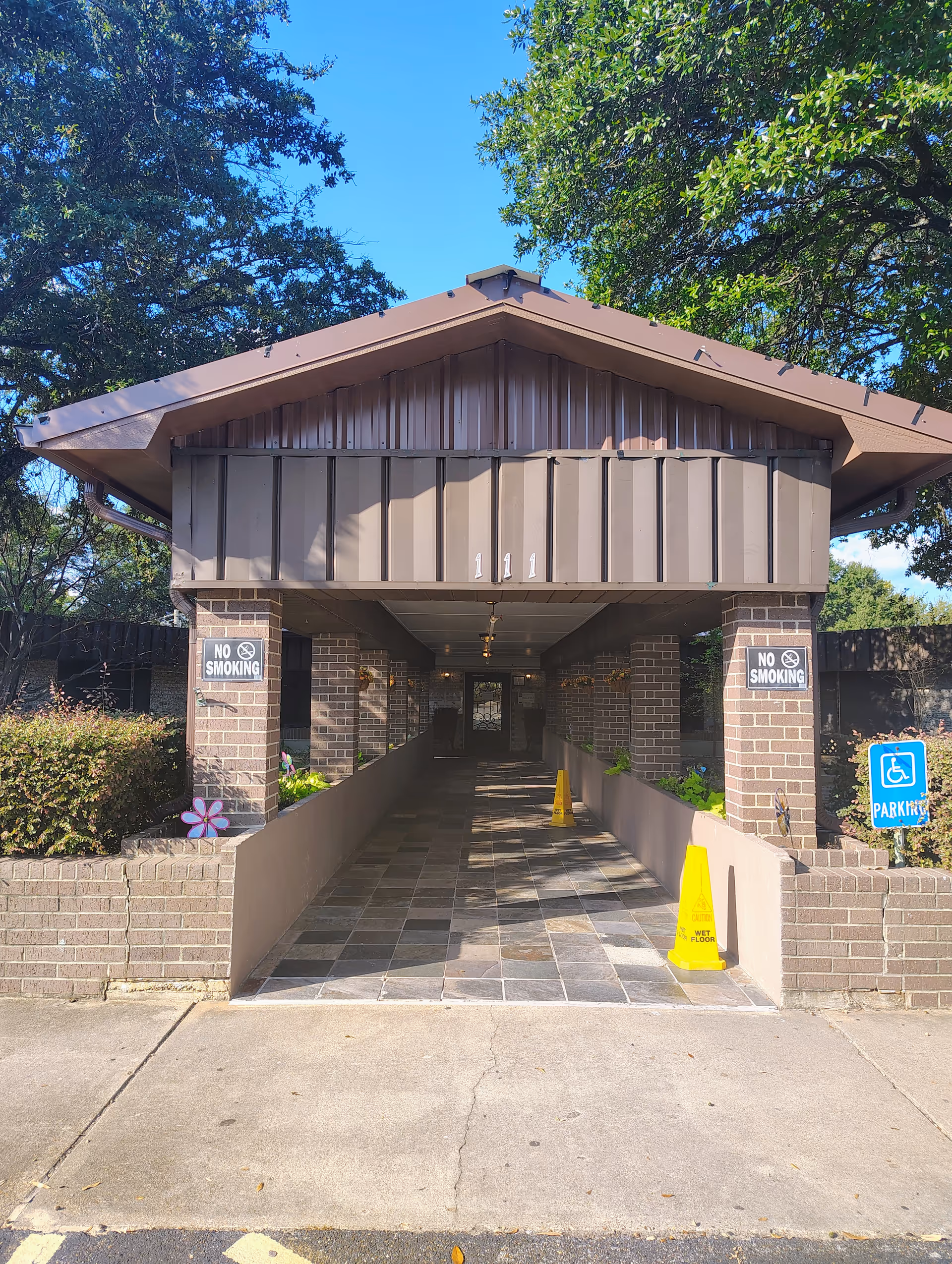 Covered entrance to Havencare Nursing and Rehabilitation Center with brick pillars and no smoking signs.