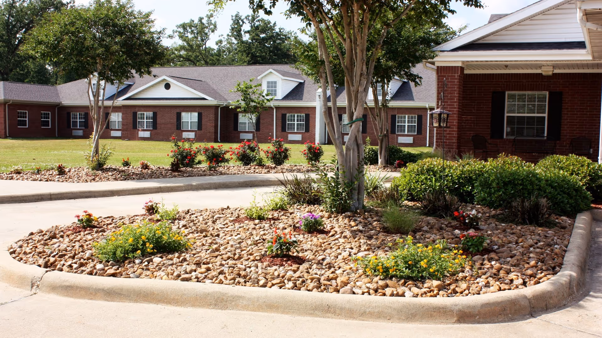 Exterior view of Castle Pines Health and Rehabilitation with landscaped rock beds and driveway.