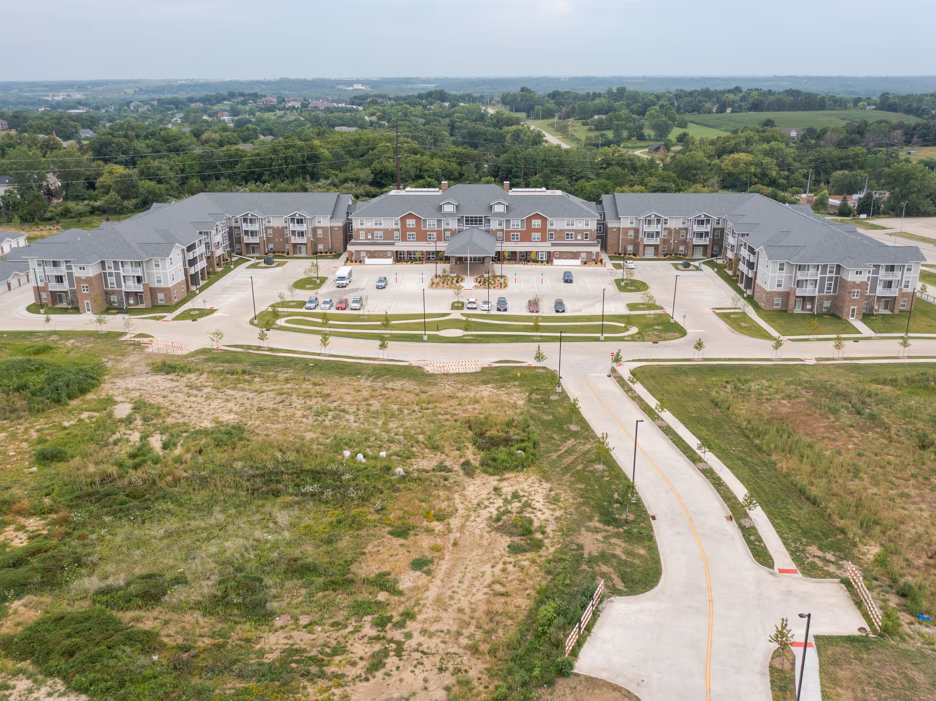 Aerial view of Glen Meadows senior living campus with brick buildings and parking.