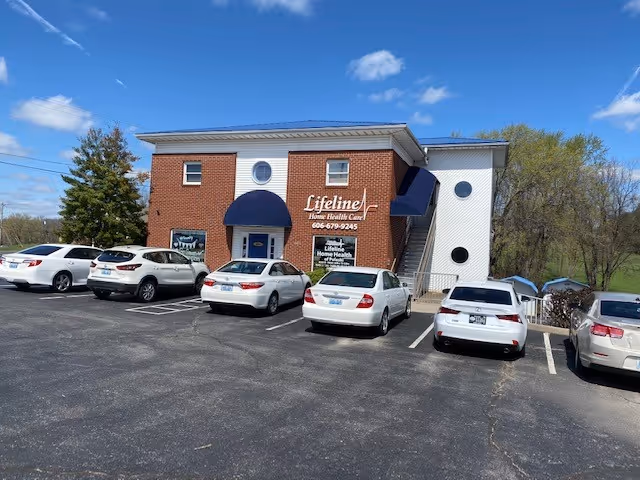 Brick Lifeline Health Care of Pulaski building exterior with blue awnings and parked cars.