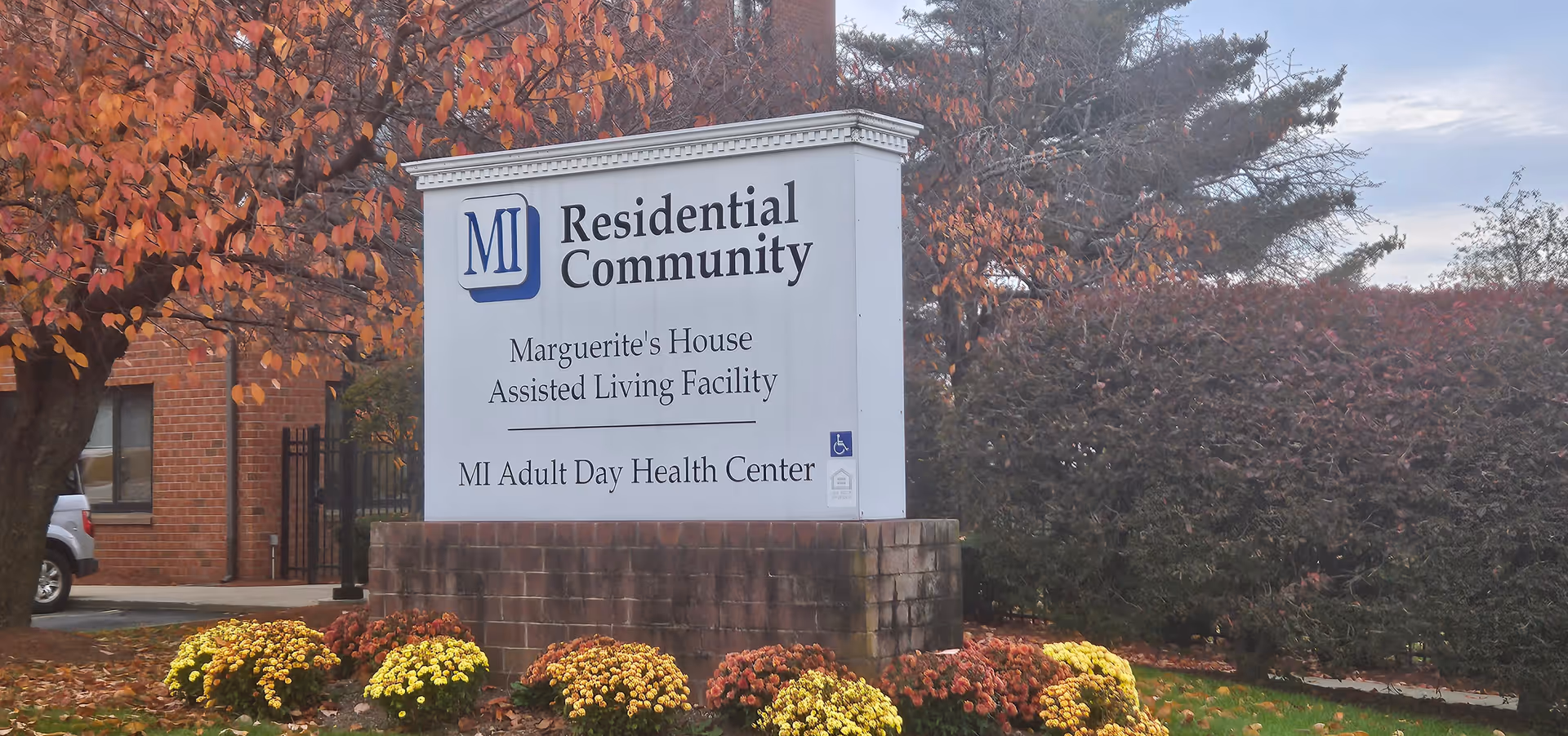 Large white sign for Residential Community with Marguerite's House and MI Adult Day Health Center.