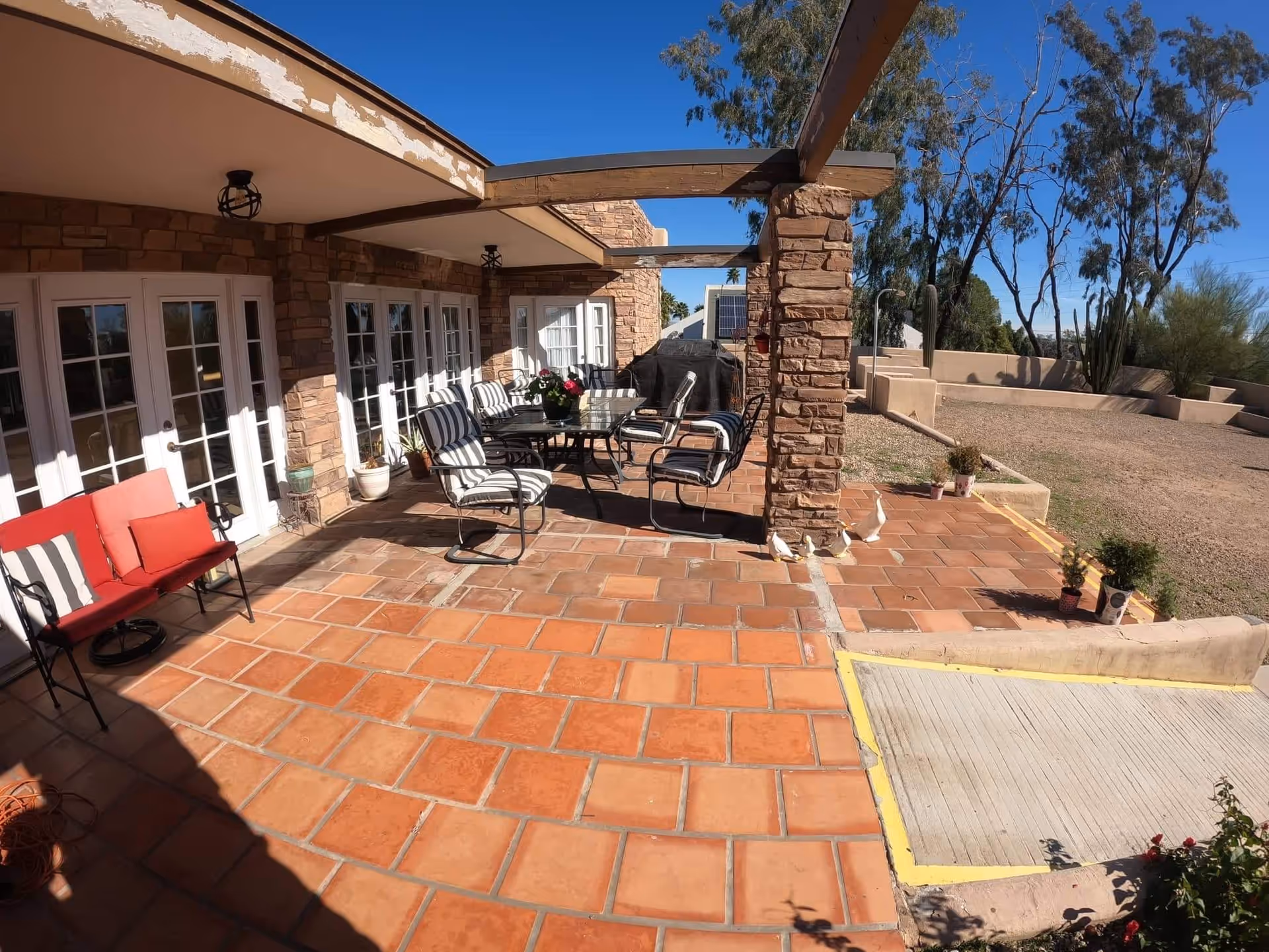 Outdoor brick patio with seating and a table outside Ronald Home Care.