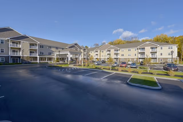 Exterior of Summit at Saratoga senior living facility with parking and landscaped grounds.