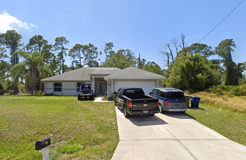 Front view of Martha's Home Care Assisted Living facility with driveway and parked vehicles.